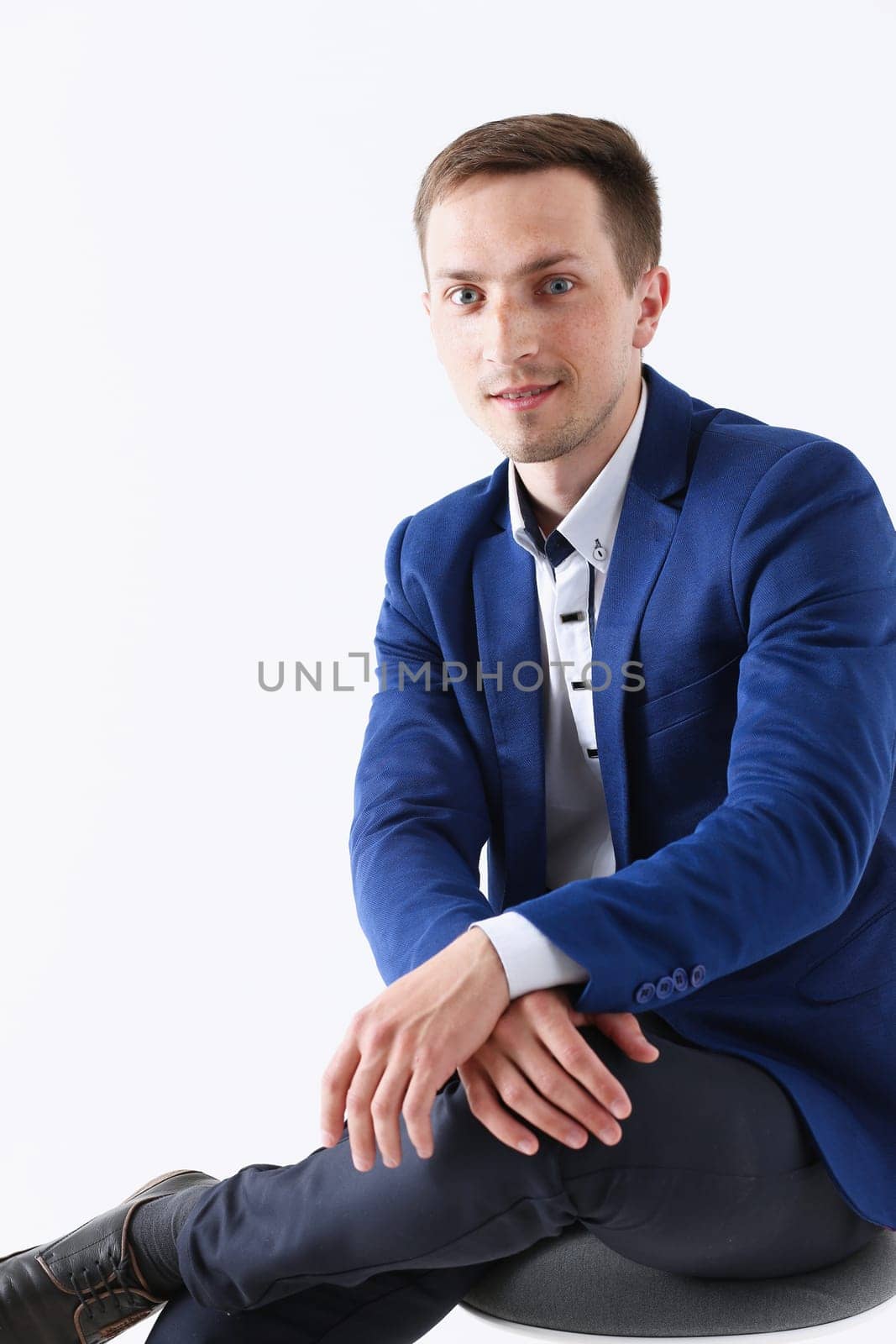 Handsome smiling man in suit and tie looking by kuprevich
