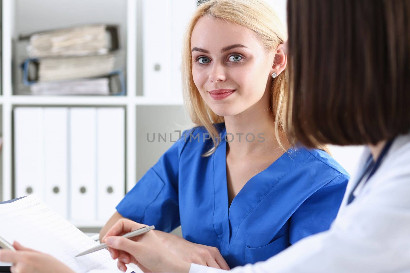 Group of doctors using laptop pc sitting in office. General practitioner portrait telemedicine therapeutist professional conversation modern communication remote cure expert assistance concept