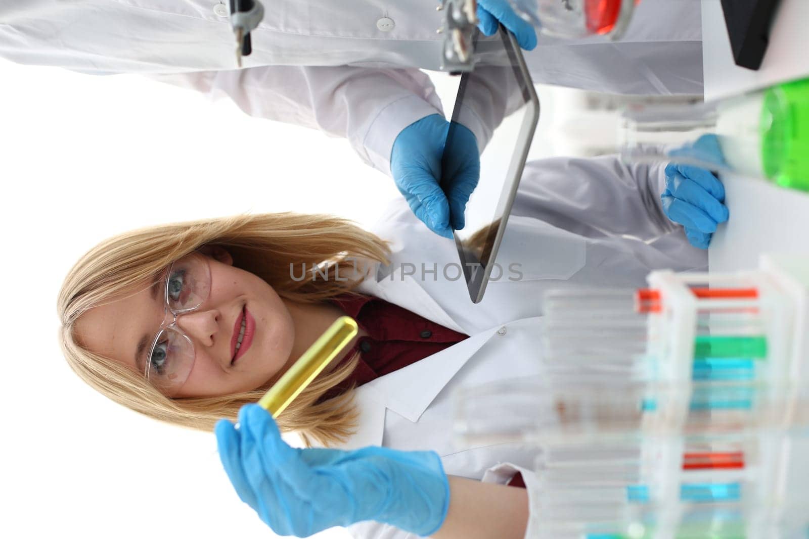 A male doctor in a chemical laboratory holds a tablet in his hand with display, you can insert a picture or an image you want to write for an advertising company