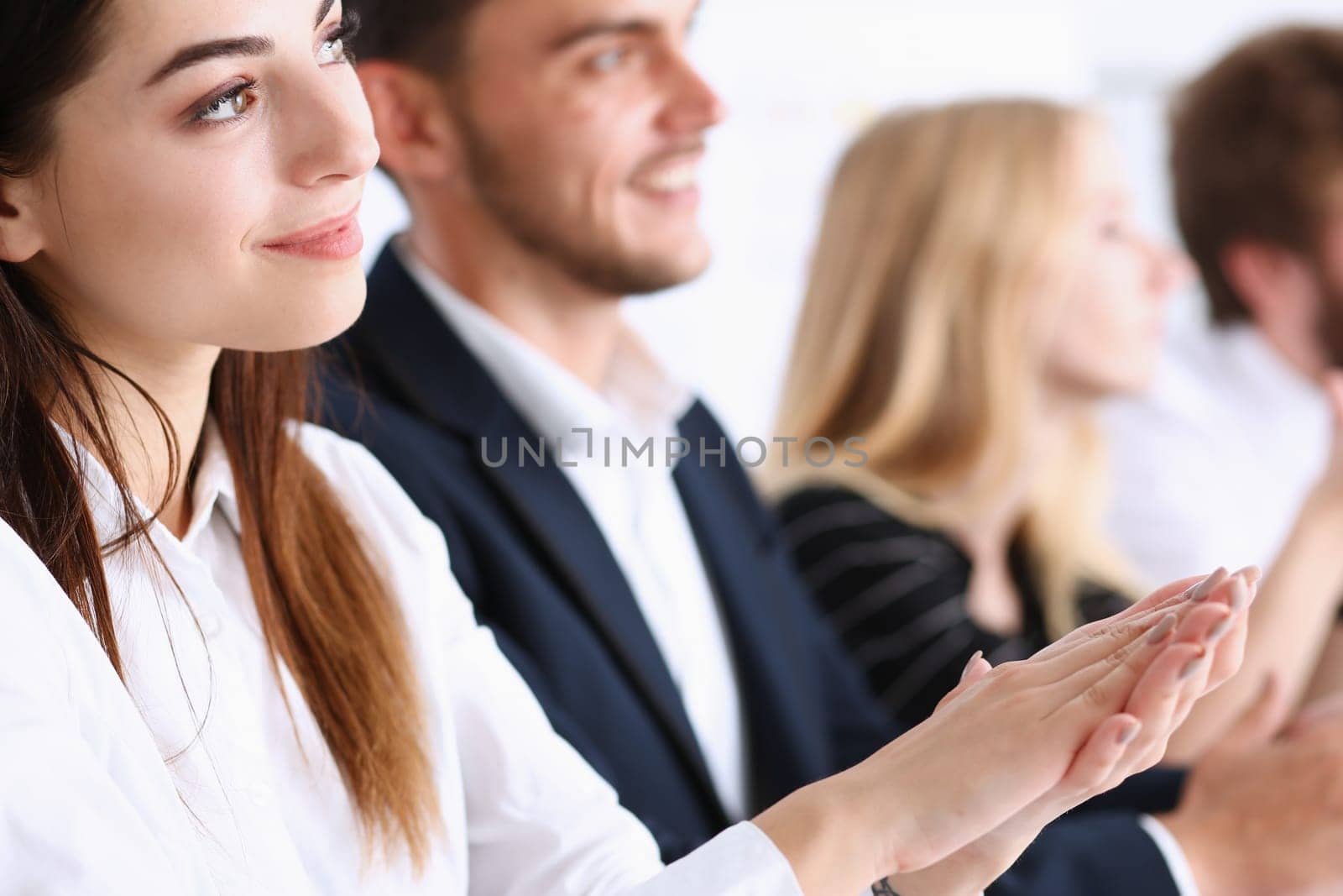 Beautiful smiling woman portrait with group of people listen carefully during seminar. Study event client conversation job customer support service case hear in court leader performance concept