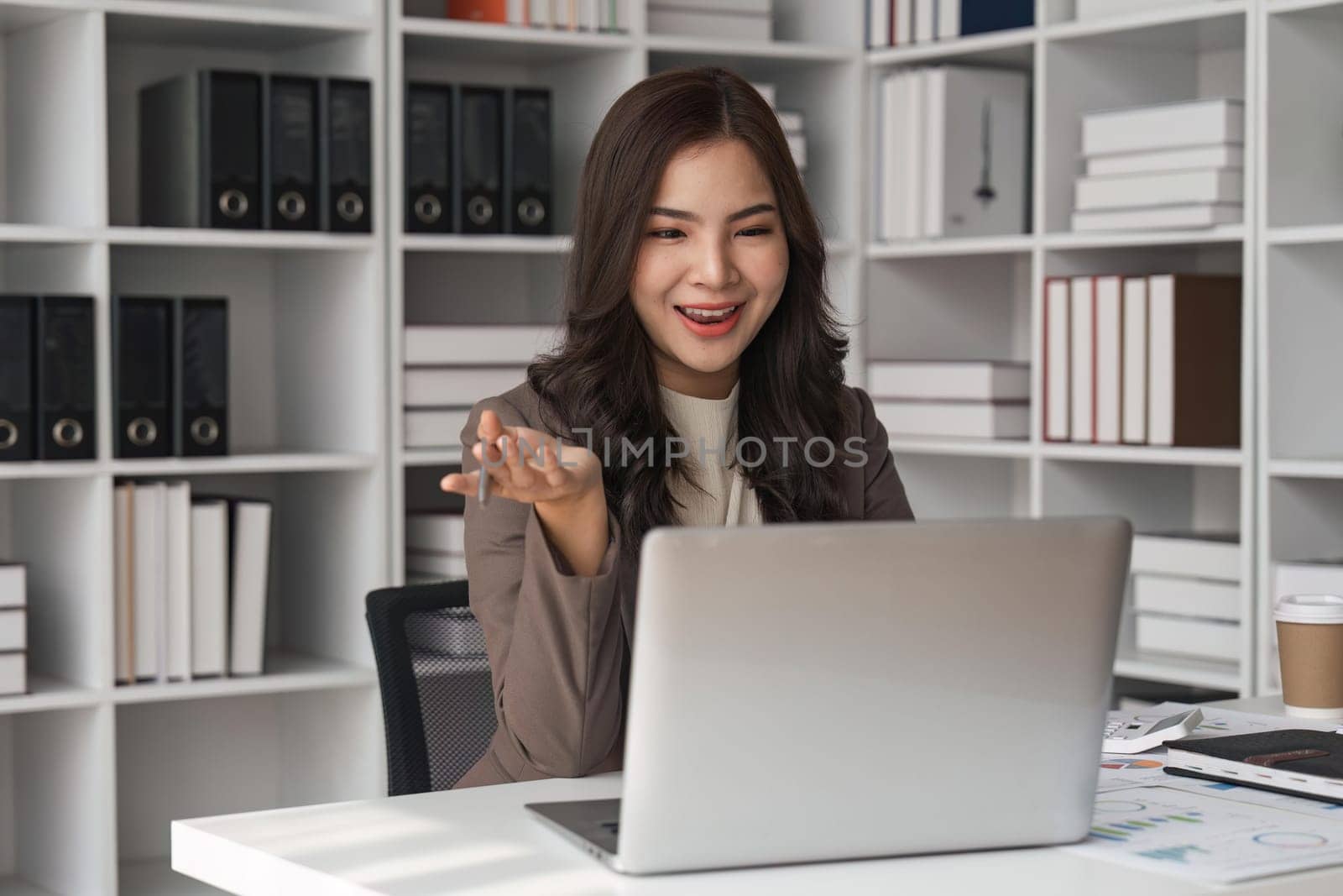 business young woman having video call via laptop in the office.