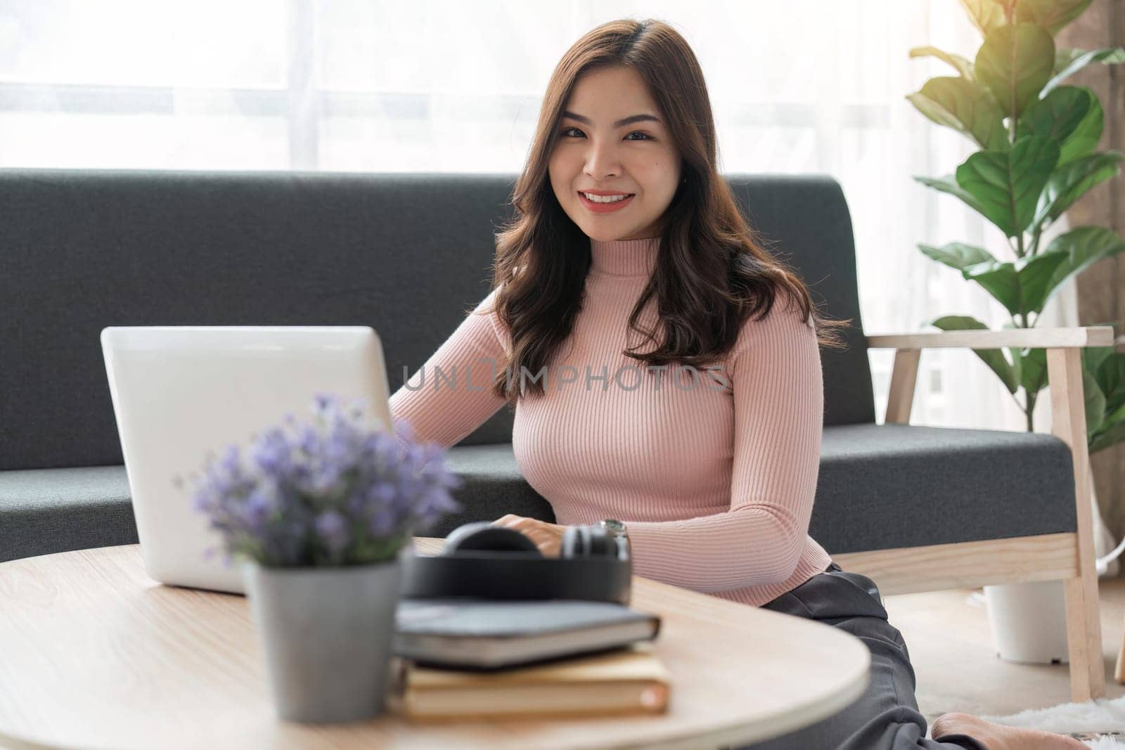 Portrait of happy asian woman work on laptop online at home. Technology concept.