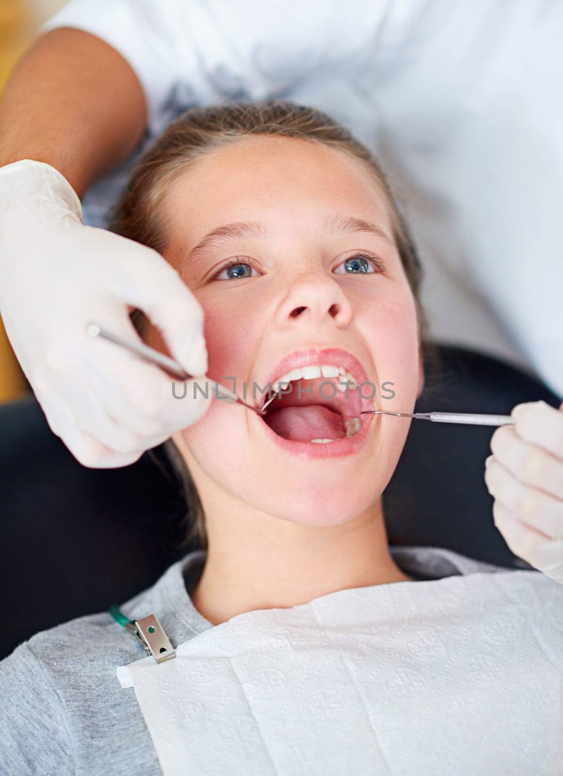 Your teeth look great. Closeup shot of a young girl having a checkup at the dentist