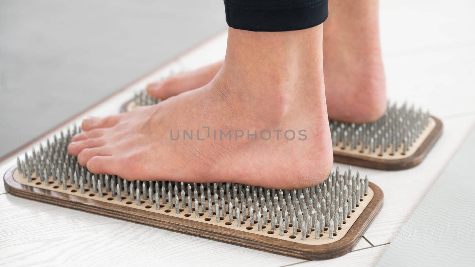 Close-up of female feet on sadhu boards