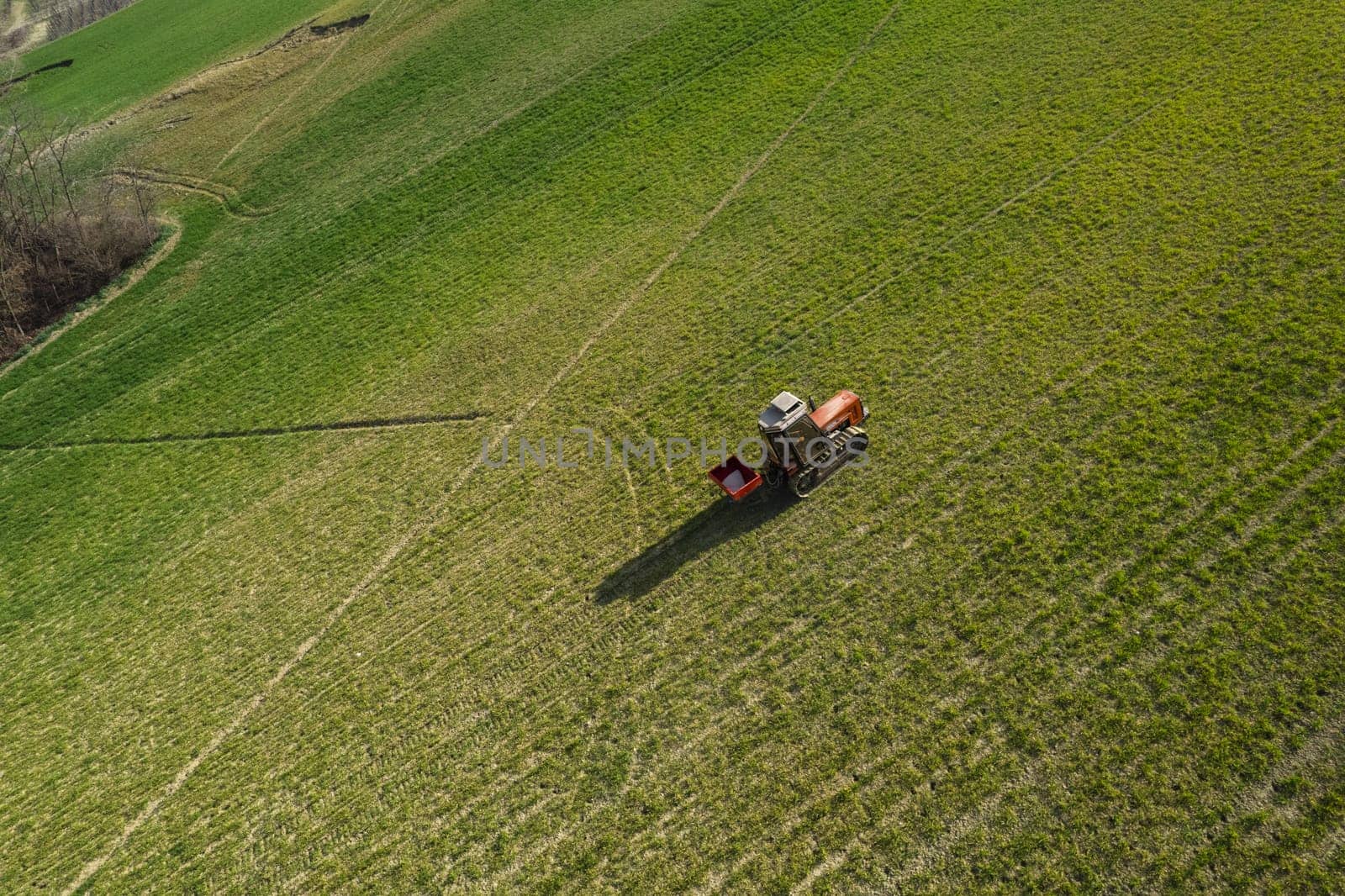 farmer driving uphill crawled tractor in the farm during spring season