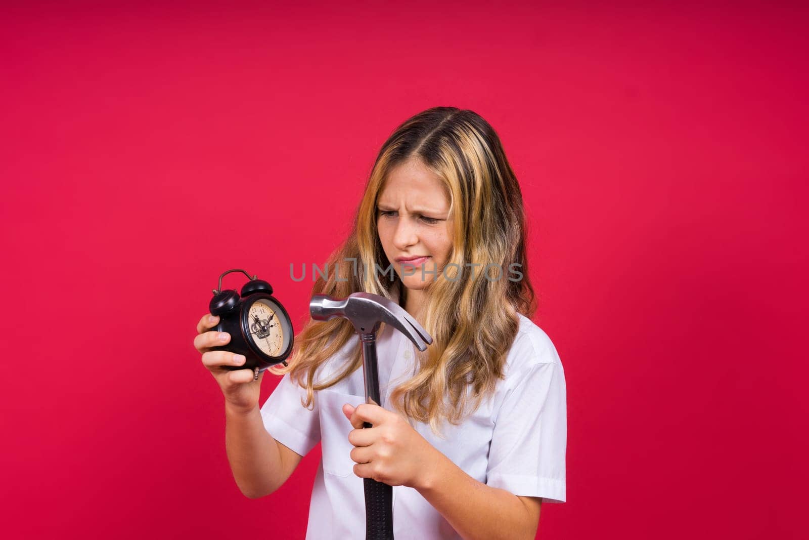 Kid girl holding hammer and alarm clock smiling with a happy and cool smile on face. showing teeth. by Zelenin