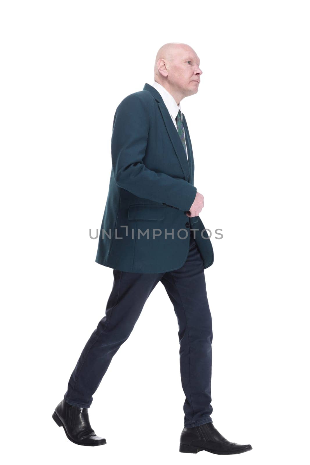 in full growth. Mature business man striding forward. isolated on a white background.