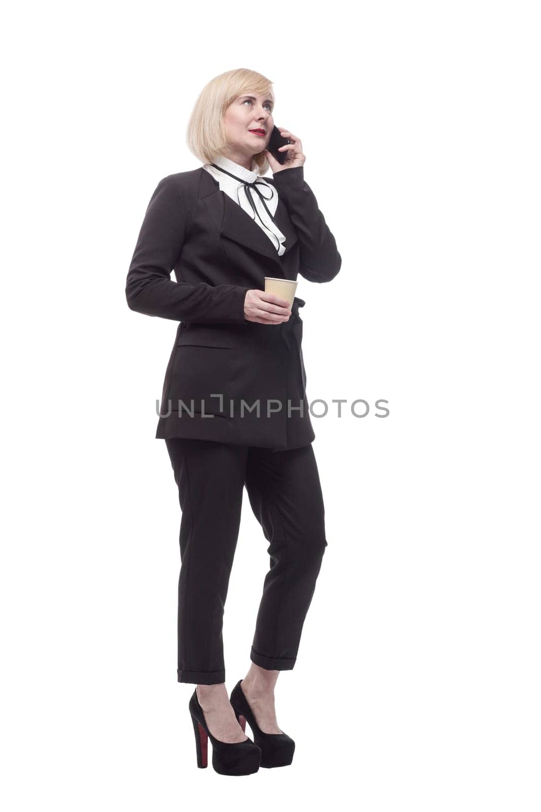 in full growth. business woman with a smartphone and takeaway coffee. isolated on a white background.
