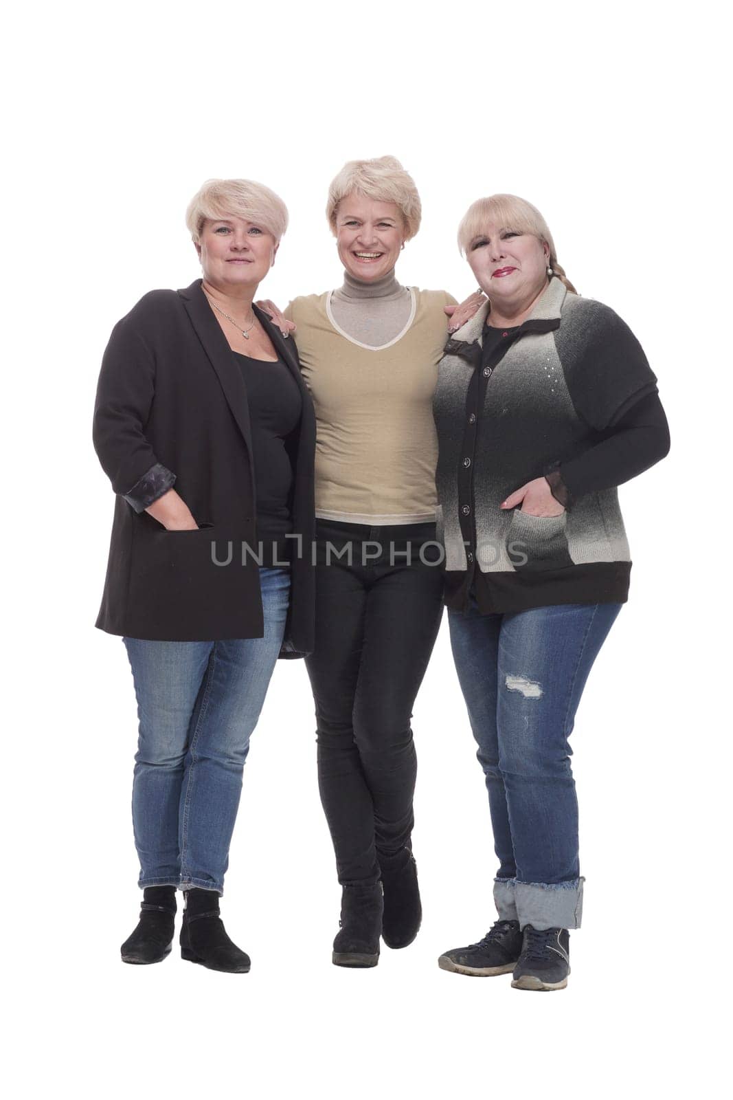 in full growth. three happy women standing together. by asdf