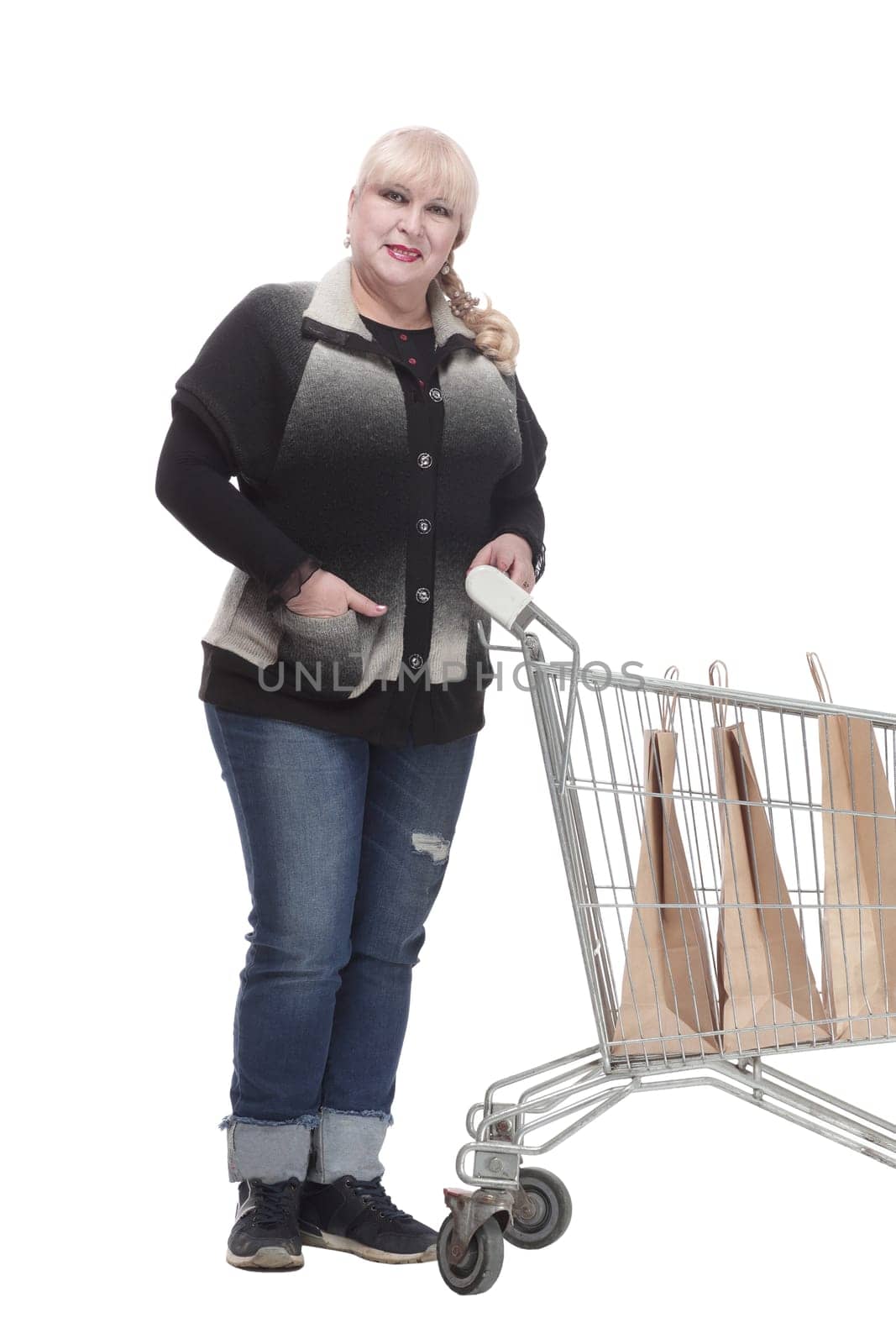 full-length. casual woman in jeans with shopping cart. isolated on a white background.