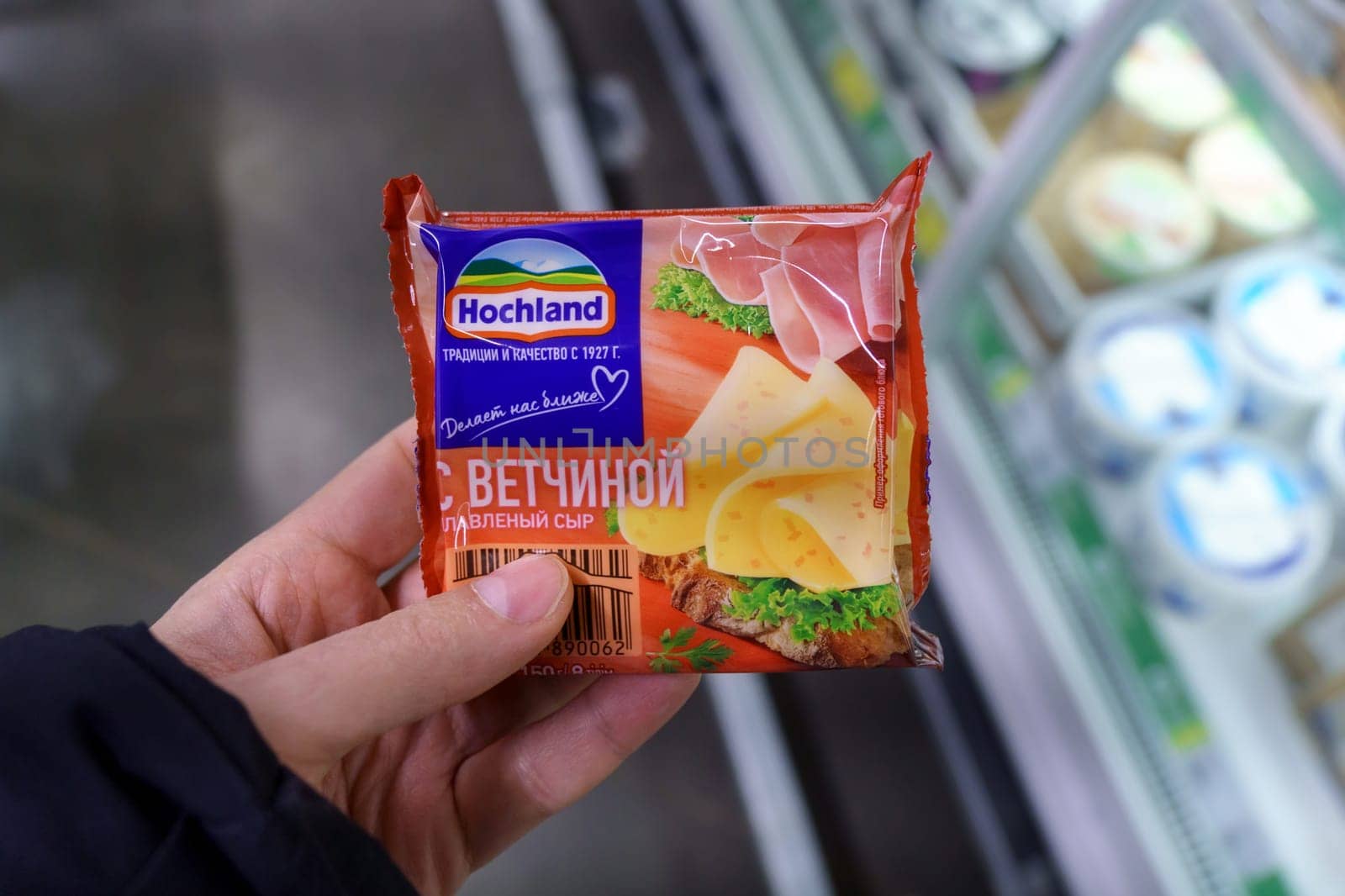 Tyumen, Russia-March 17, 2023: Pack of Hochland sliced cream cheese with ham. by darksoul72