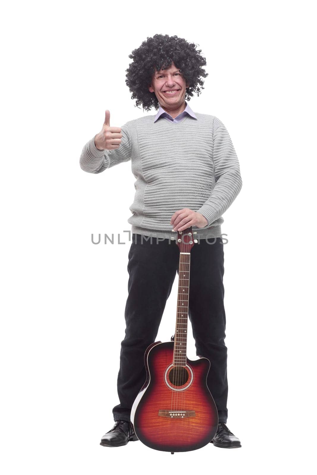 in full growth. cheerful man with a guitar. isolated on a white background.