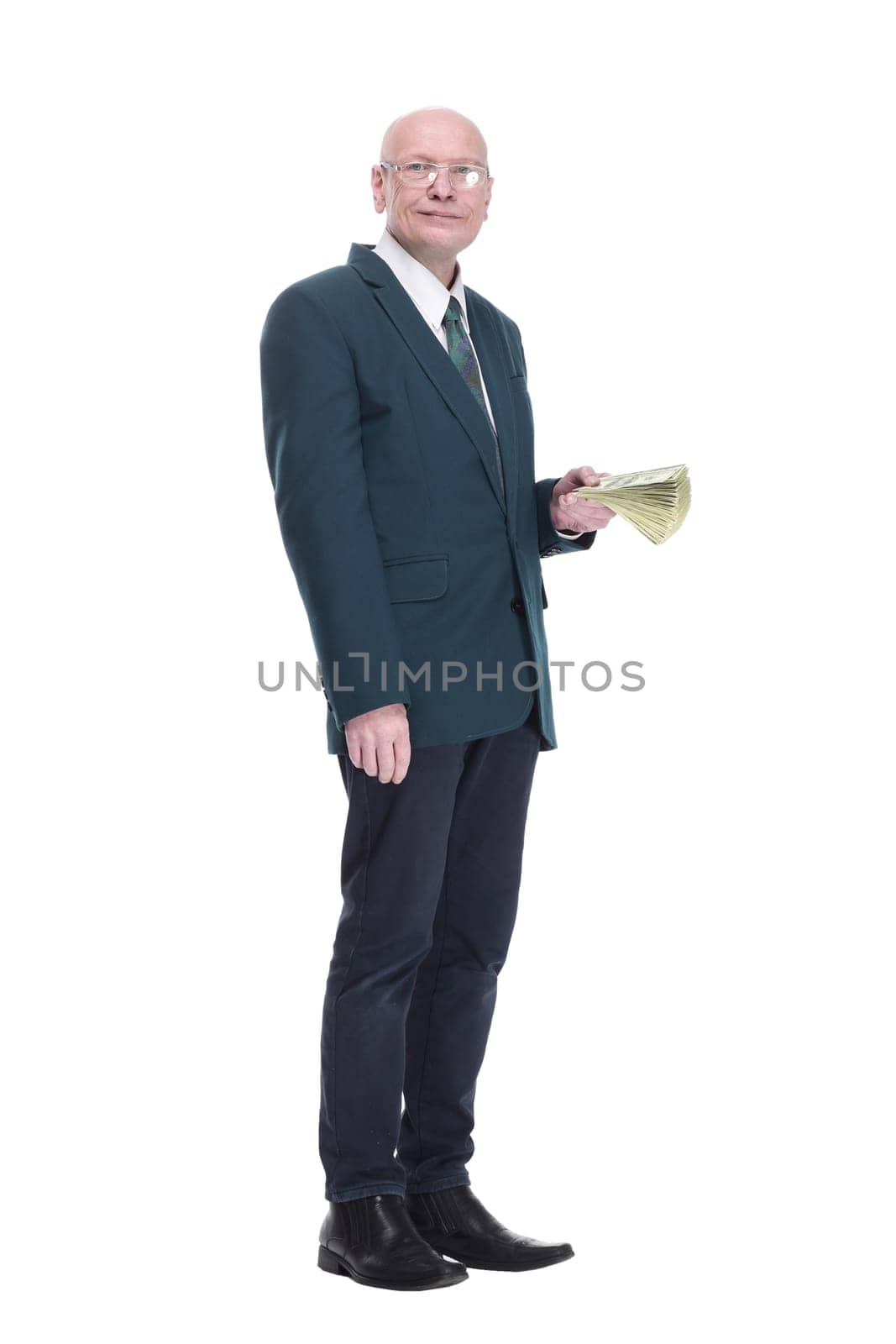 side view. personable business man with a wad of dollar bills. isolated on a white background.