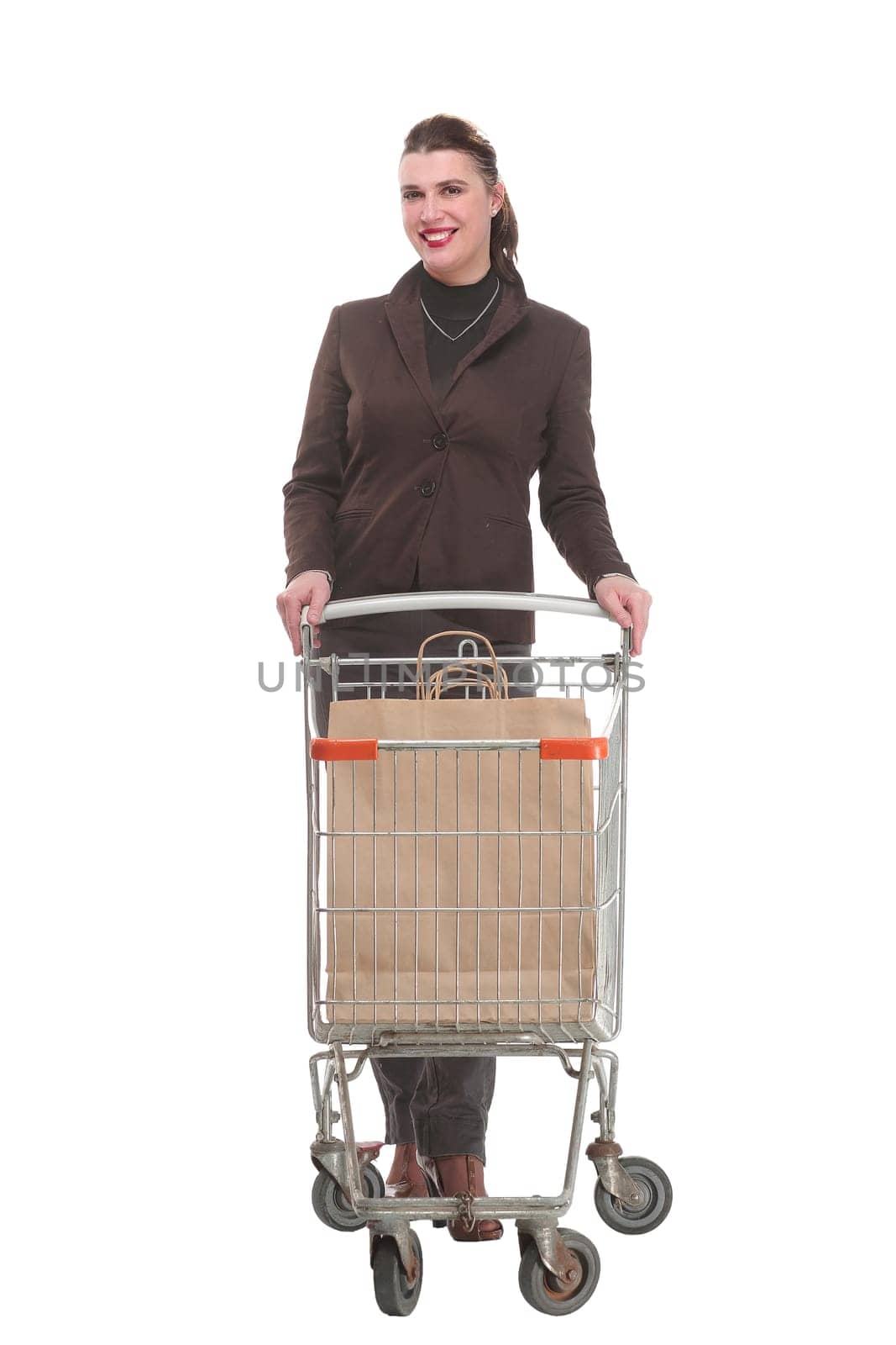 Full length portrait of a woman pushing a shopping trolley isolated on white background