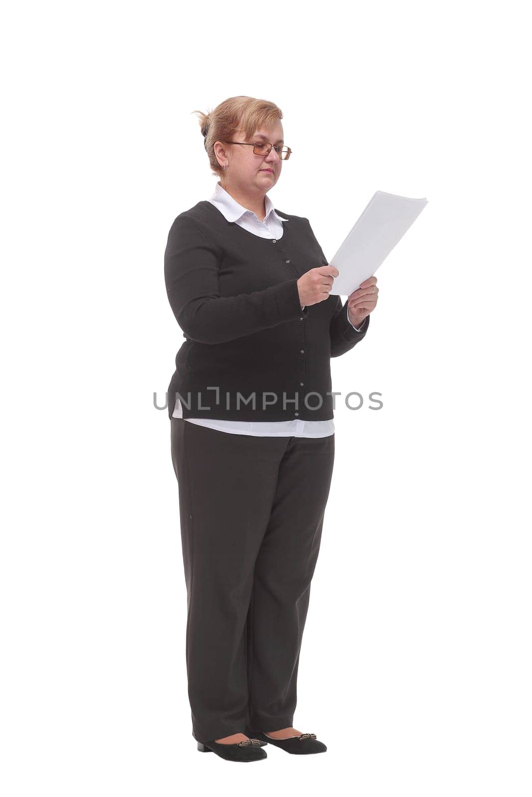 Side view of serious mature woman reading documents. Isolated white background