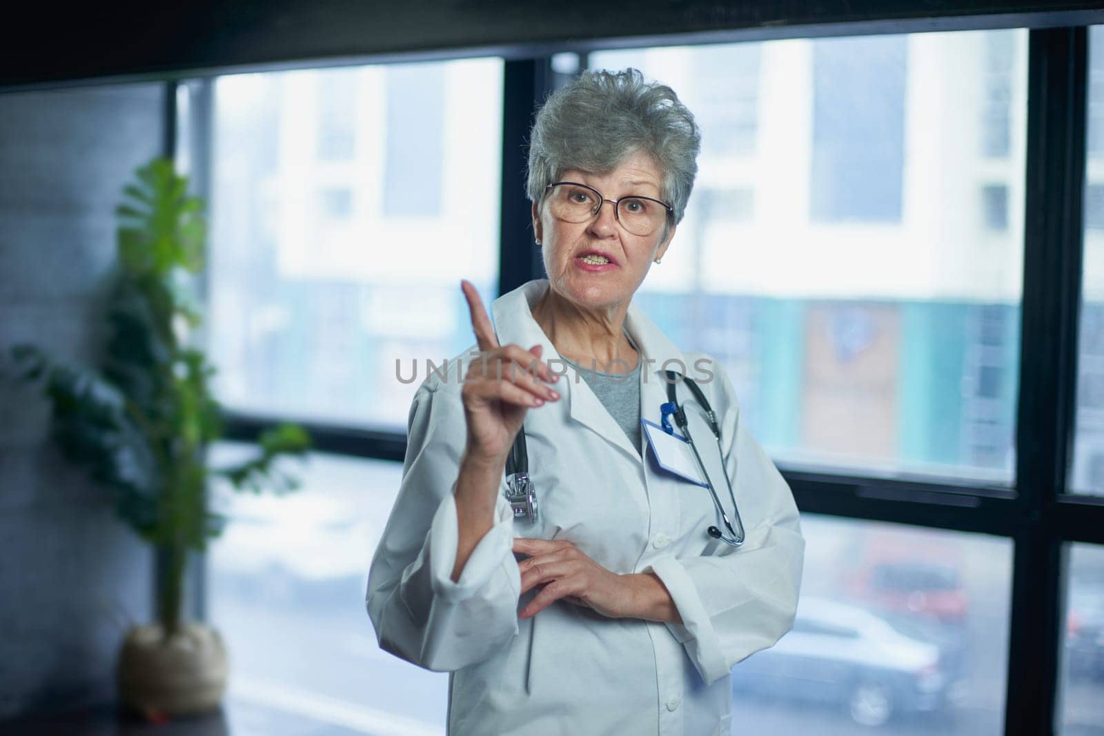 Friendly mature female doctor at hospital smiling