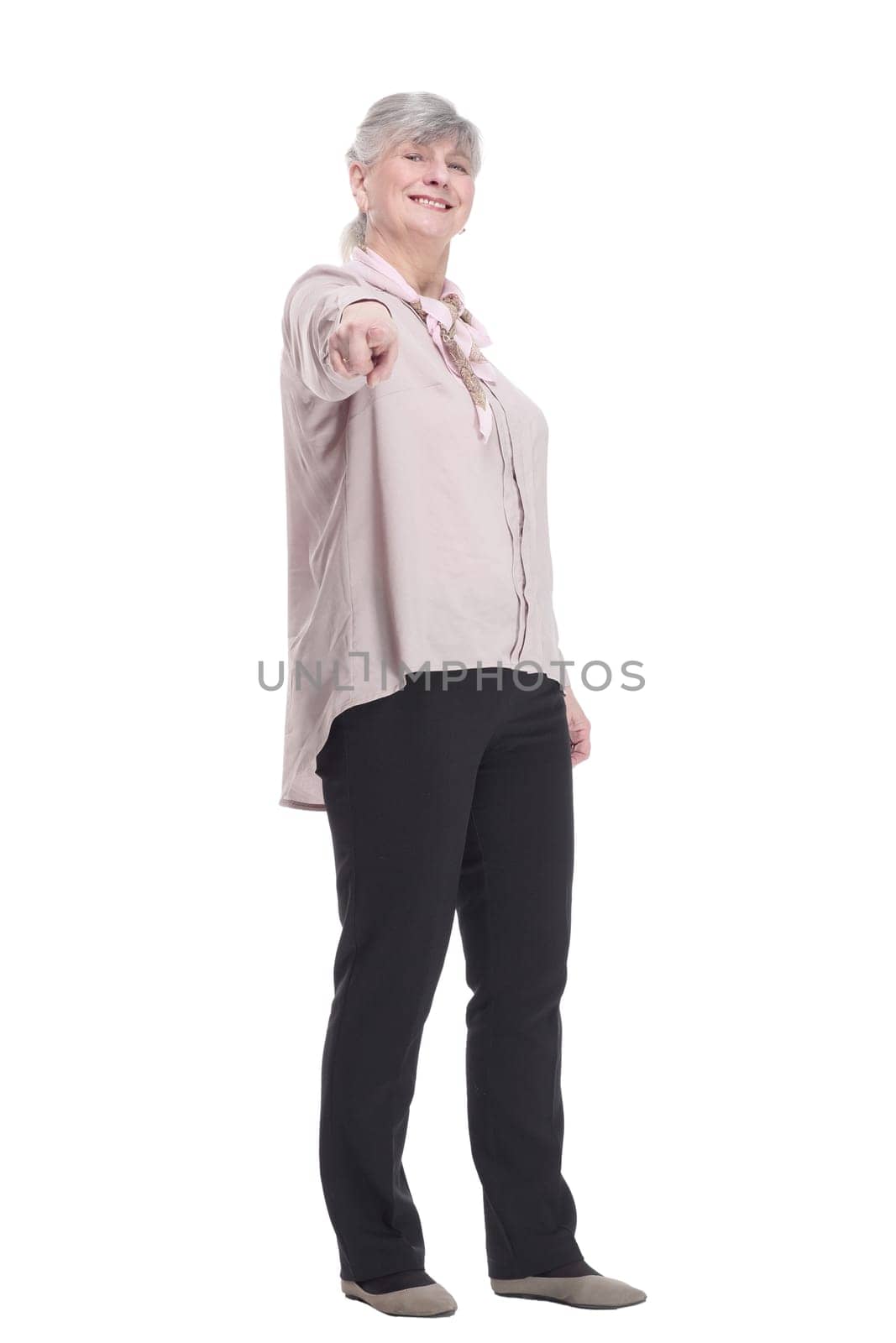 in full growth.smiling old lady pointing at you. isolated on a white background.