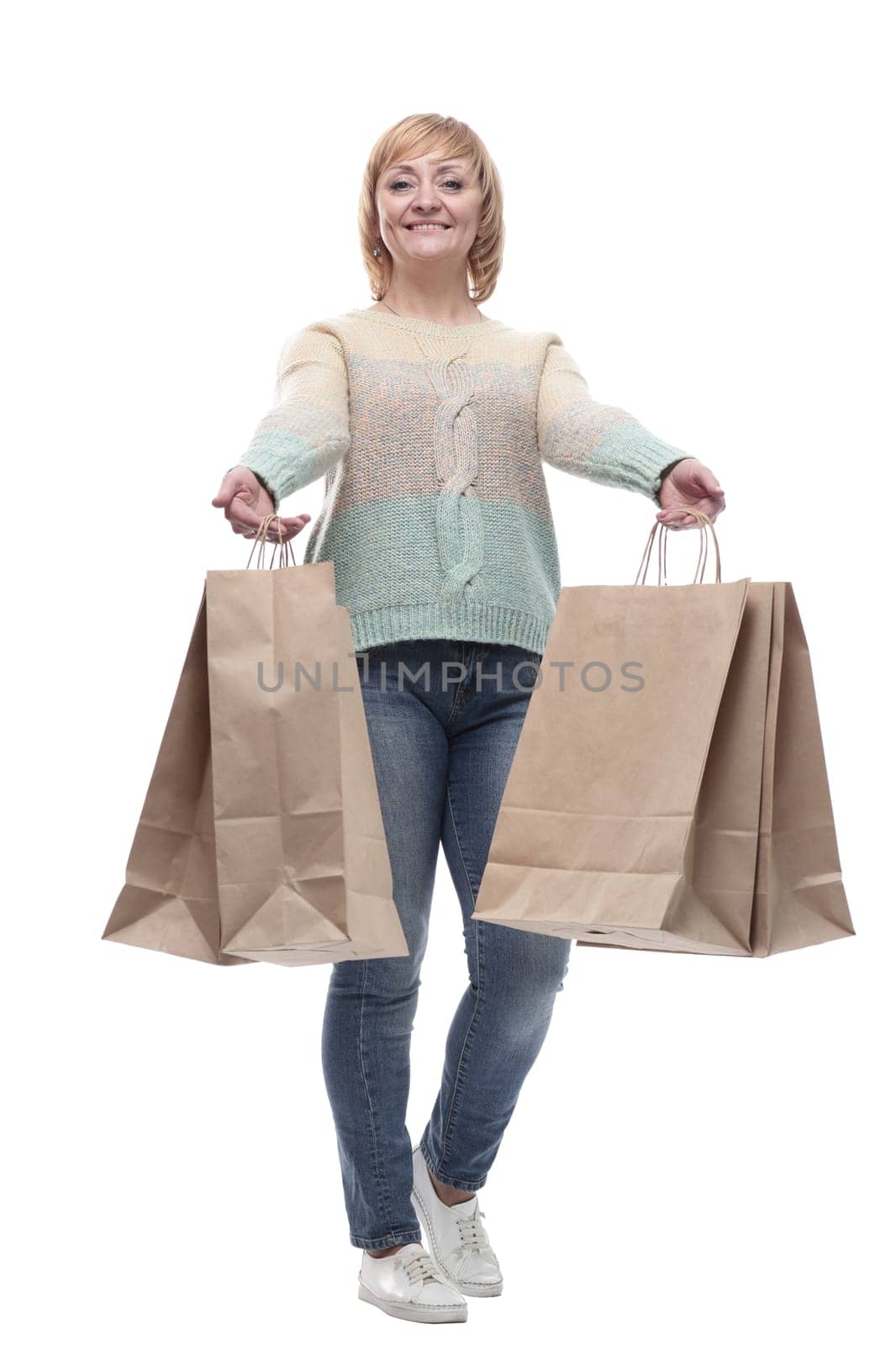in full growth. attractive casual woman with shopping bags . isolated on a white background.