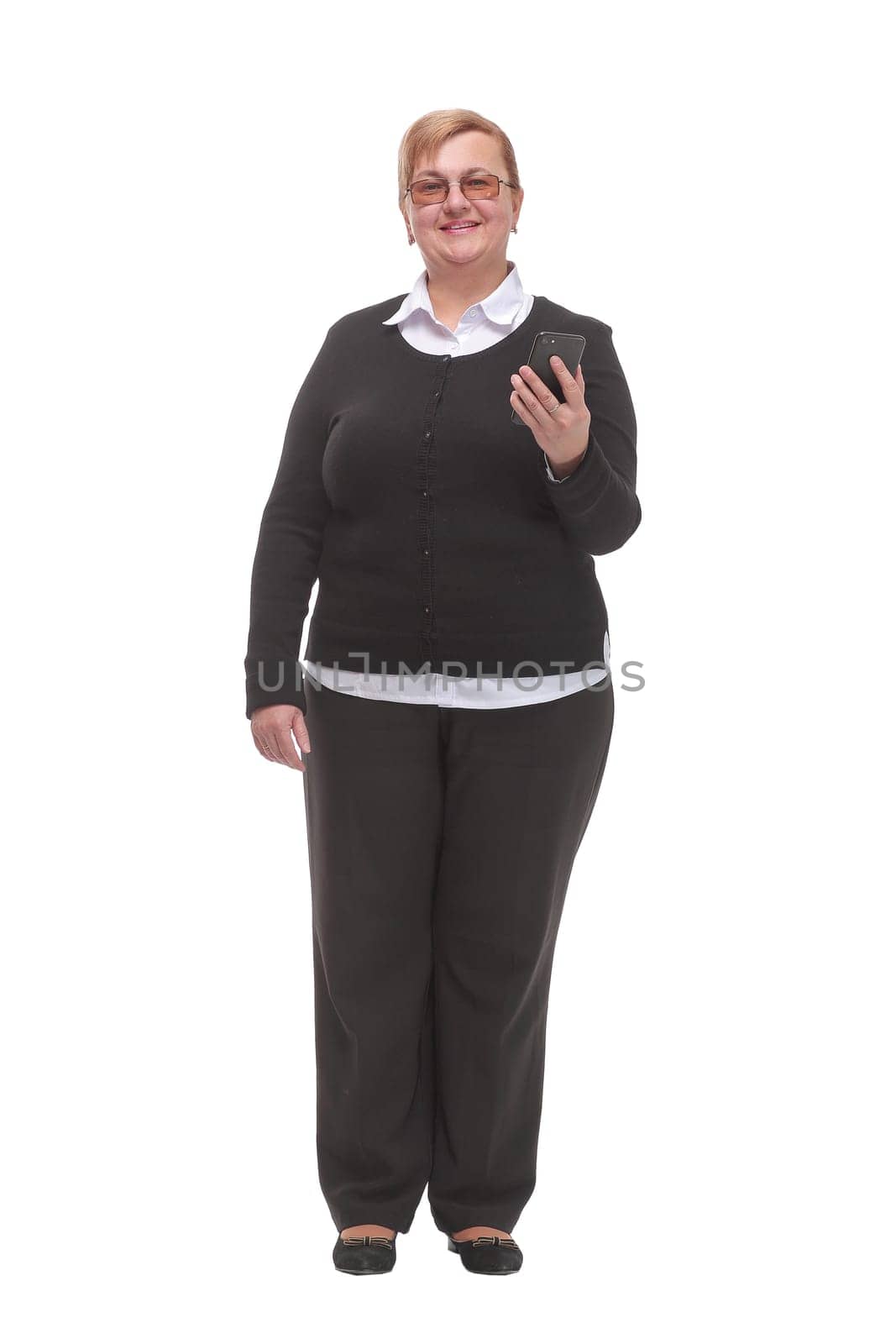 Happy senior woman with a smartphone looking at camera. Isolated on white background.