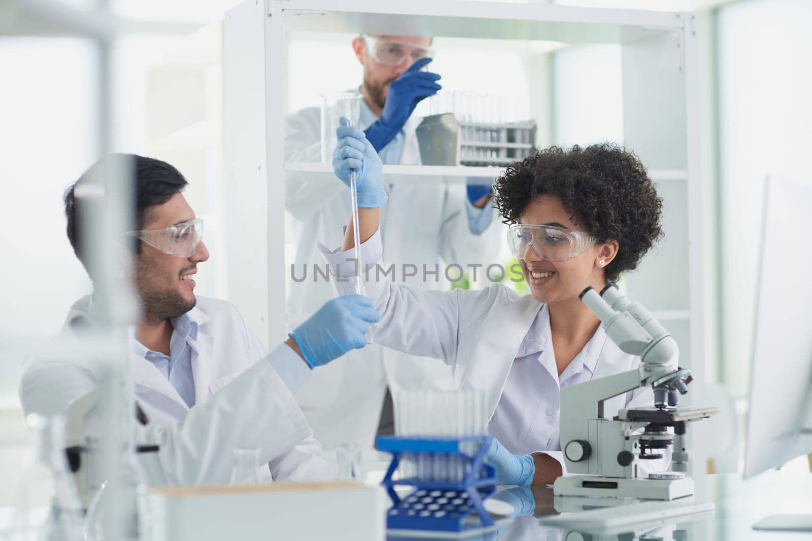 Team of Scientists Working Using Microscope, Analysing Microbiology Samples