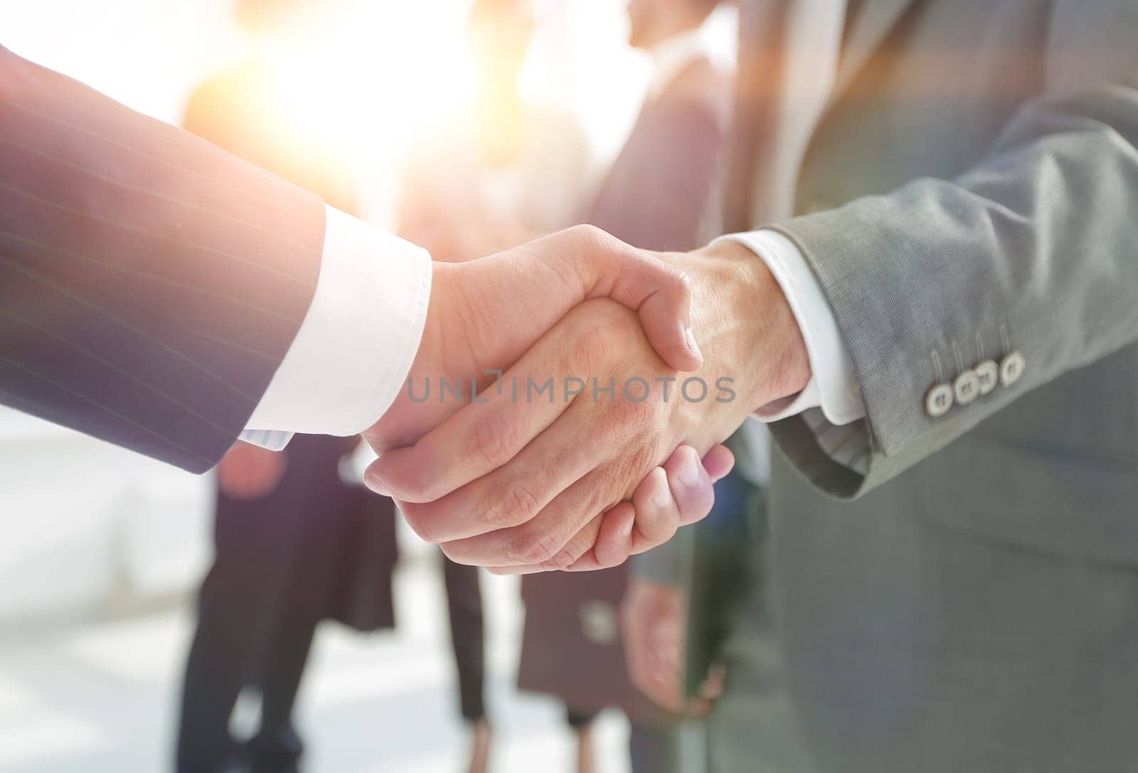 closeup.reliable handshake of business partners on the background of business team