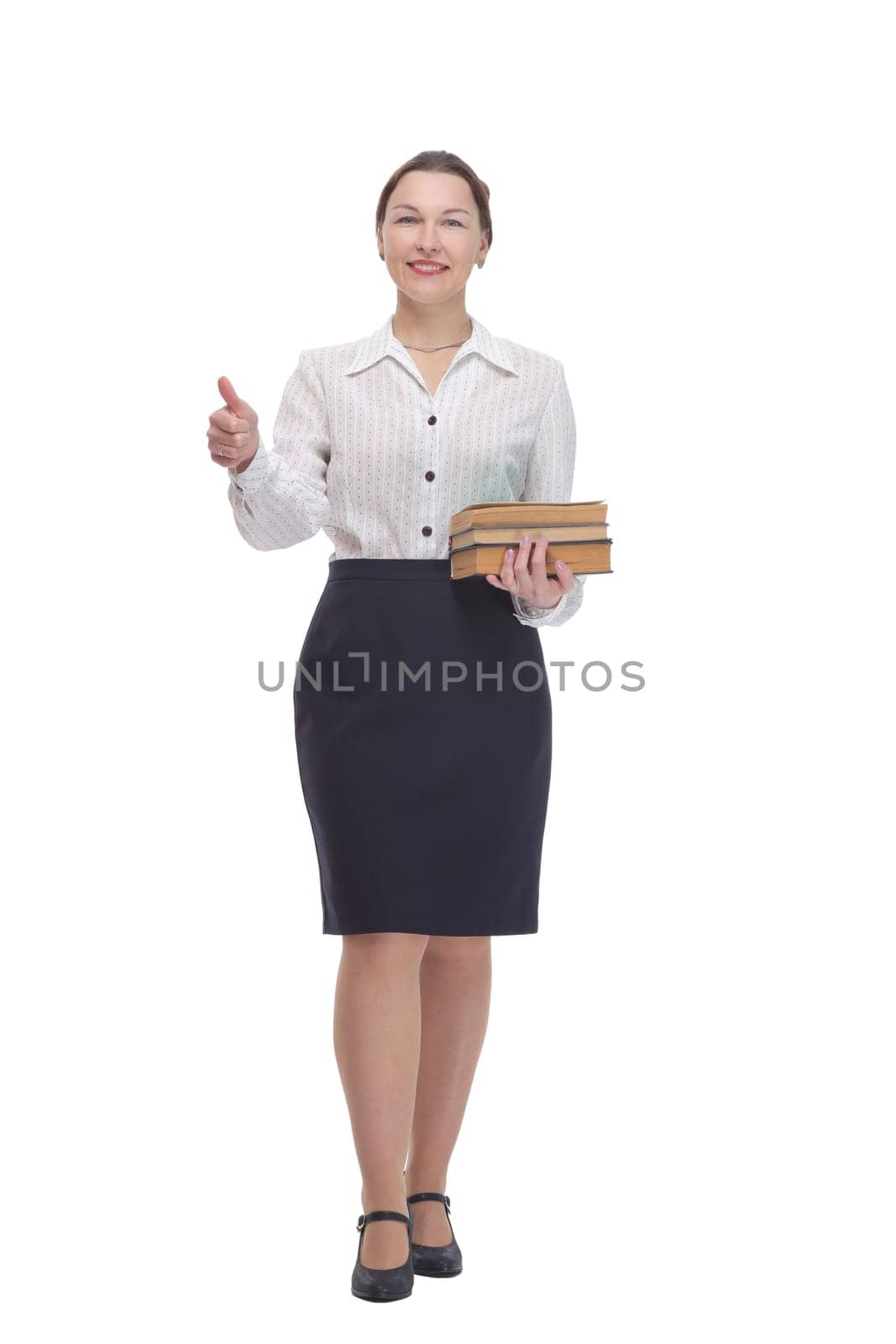 in full growth. businesswoman with a stack of books. isolated on a white background.