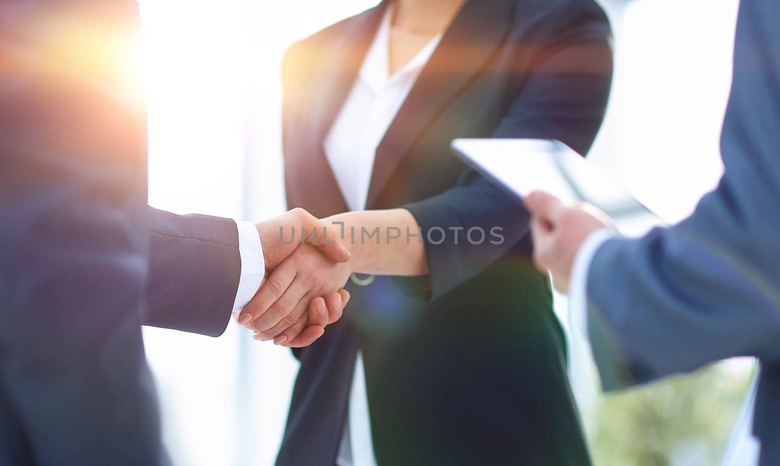 Businesswoman shaking hands with a businssman during a meeting.concept of partnership