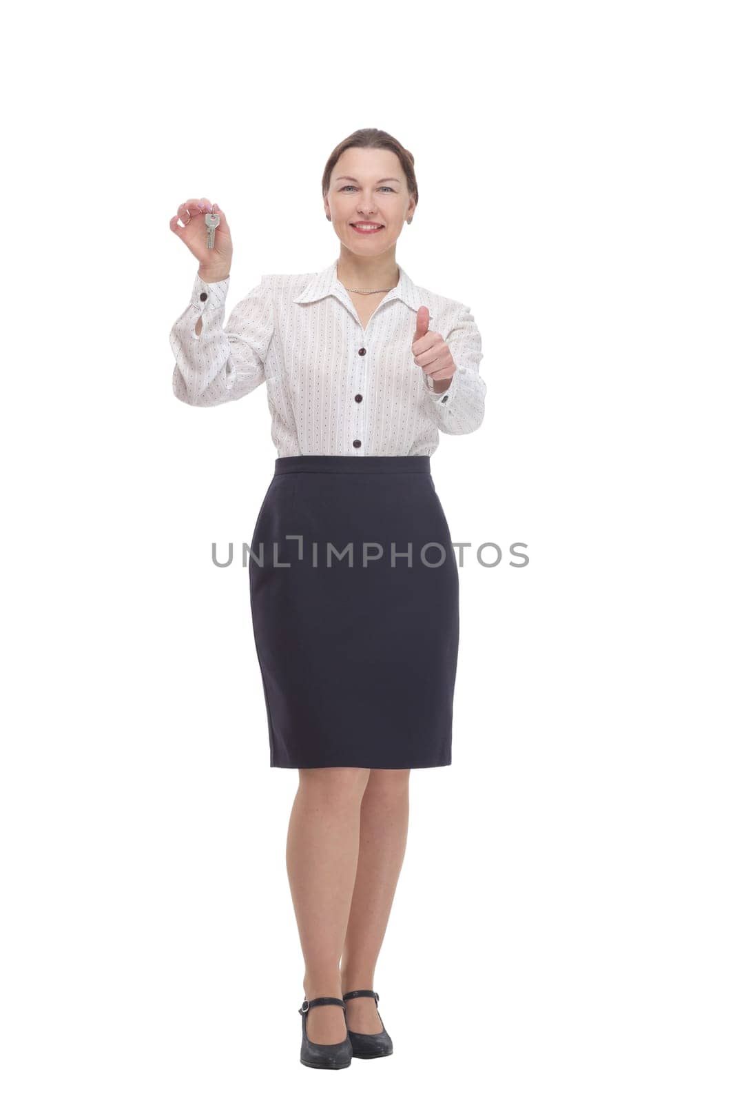 in full growth.business woman with keys in hand. isolated on a white background.