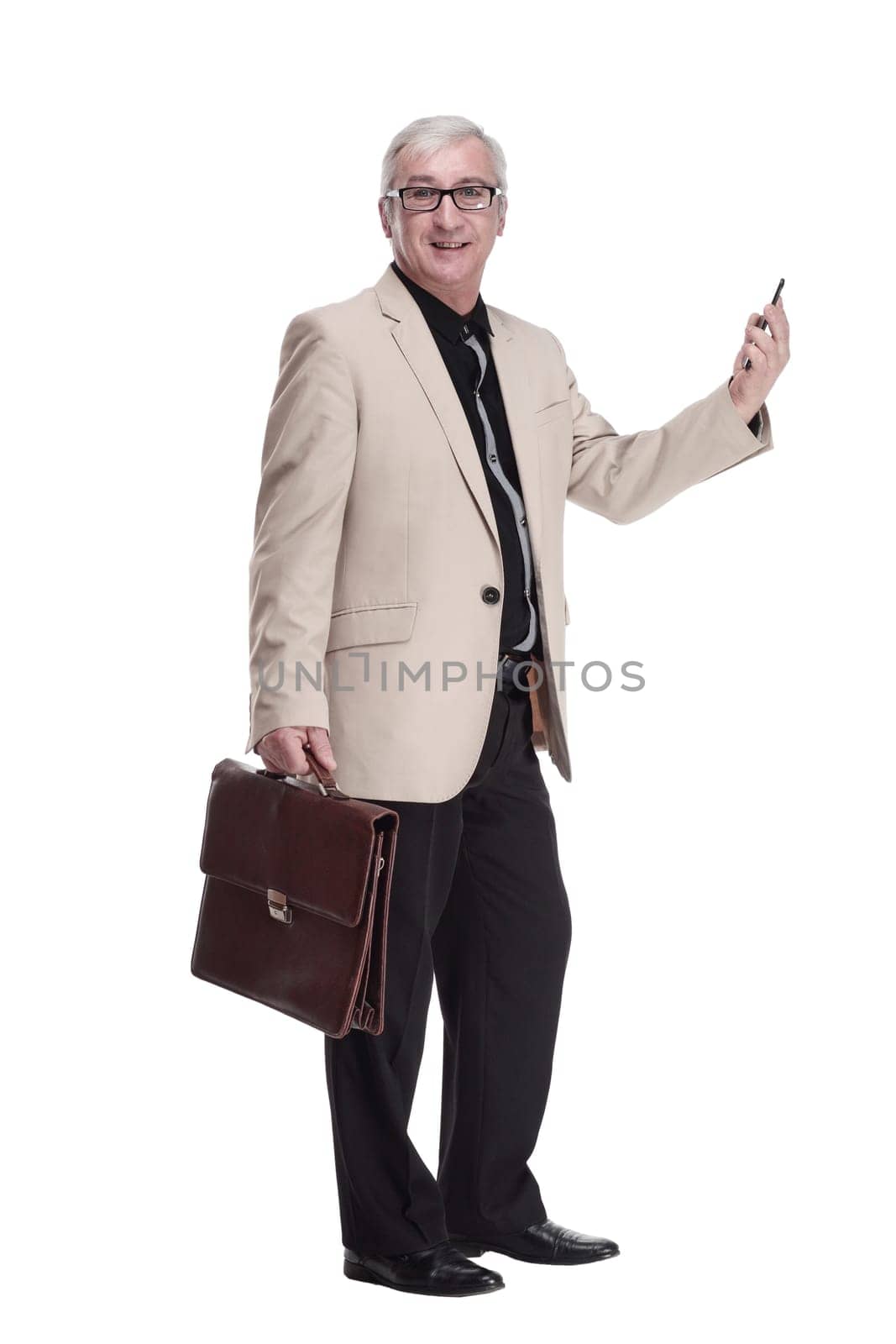 in full growth. intelligent mature man with a smartphone . isolated on a white background.