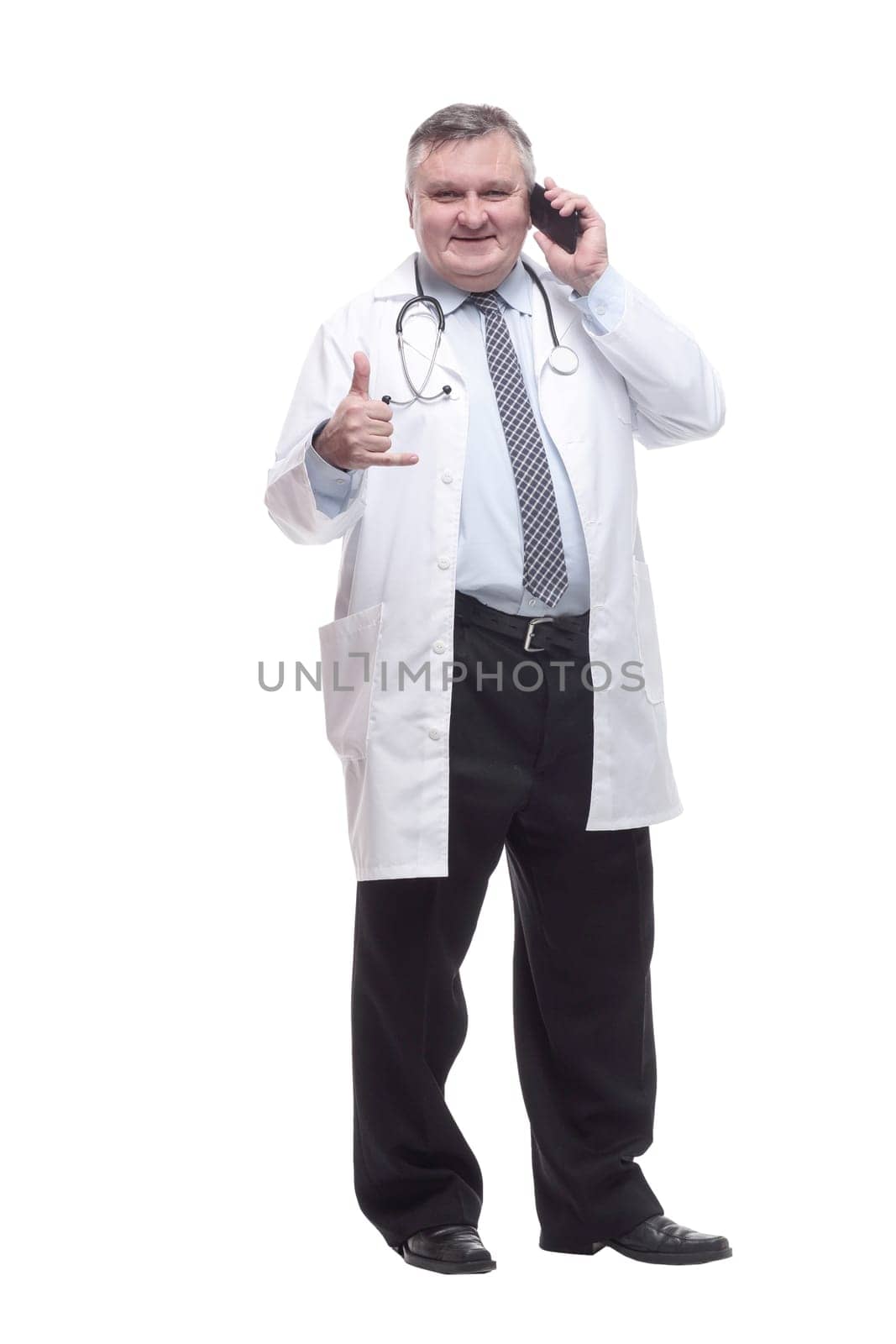 in full growth. smiling doctor with a smartphone. isolated on a white background.