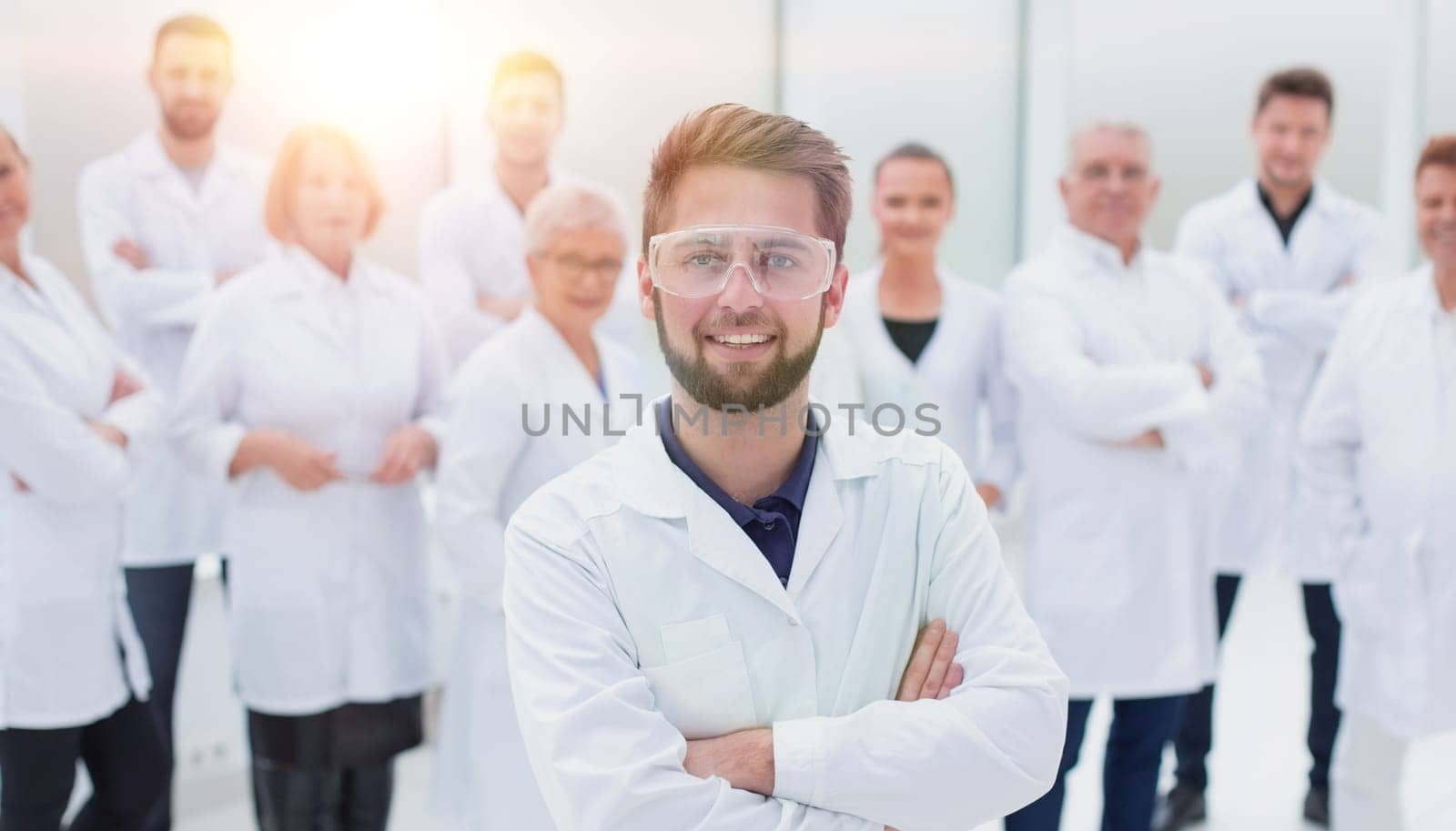 confident scientific leader standing in front of a team of young scientists. concept of health protection.