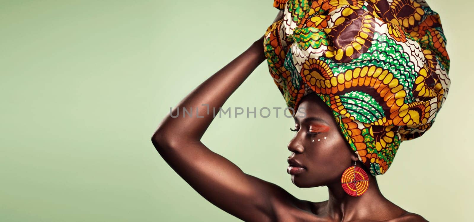 Makeup, fashion and black woman in head wrap in studio for culture, glow and cosmetics on green background with space. Beauty, skincare and african female model with pride, tradition and confidence by YuriArcurs