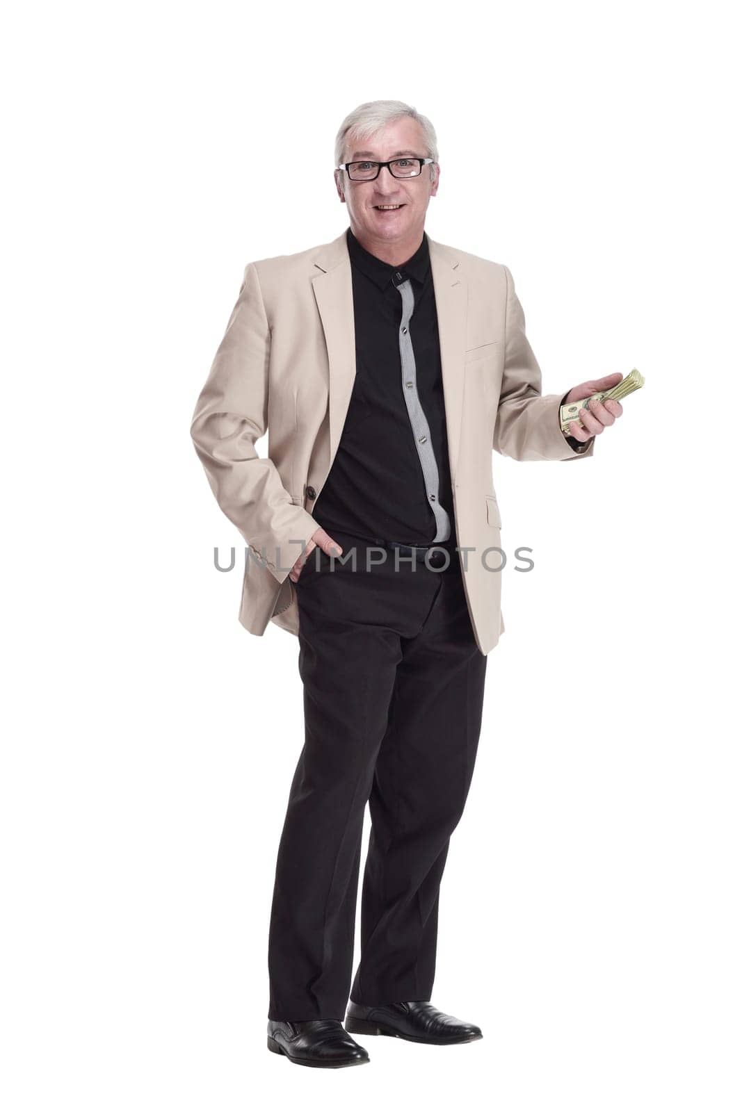 in full growth. happy intelligent man with banknotes. isolated on a white background.