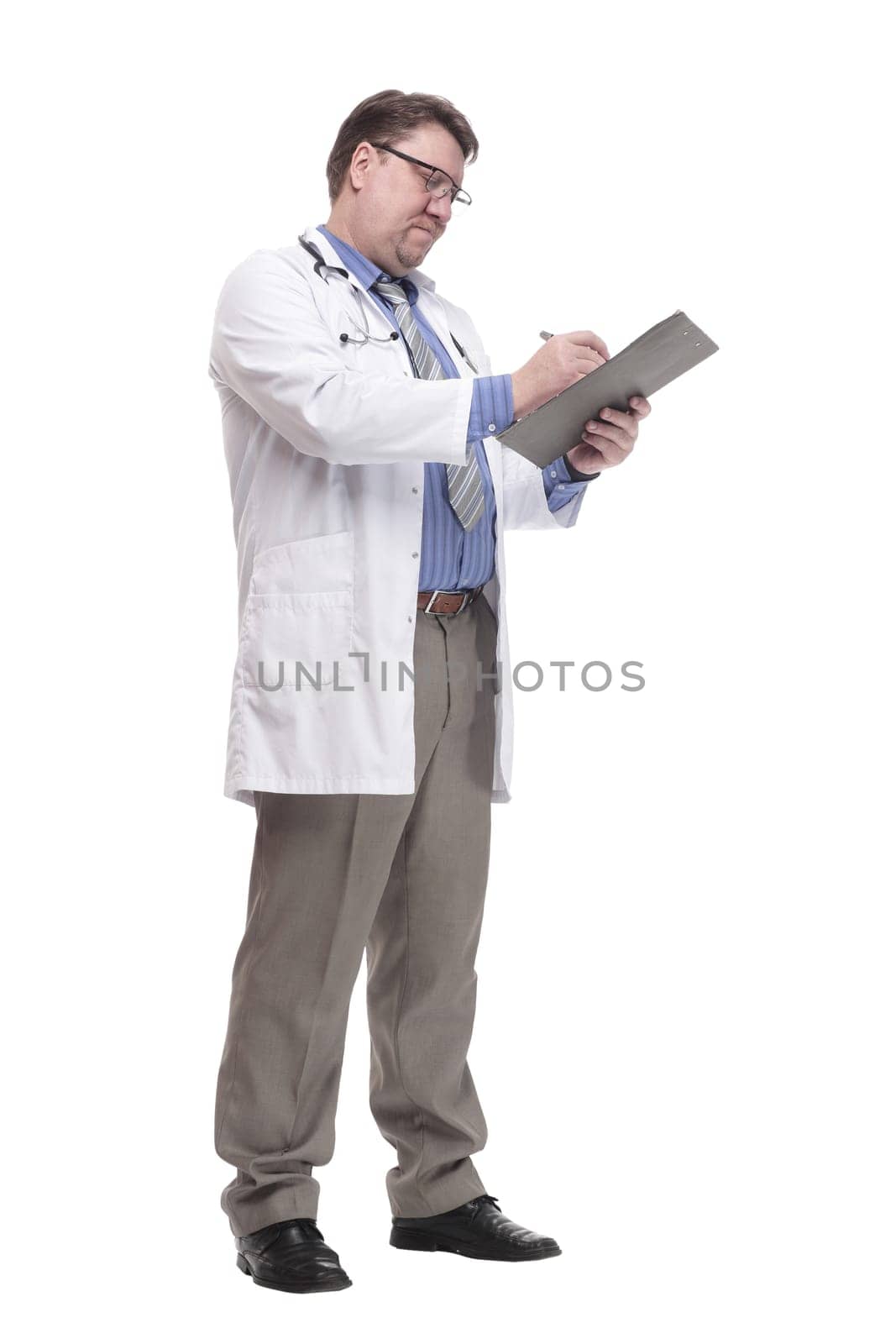 in full growth. qualified doctor with a clipboard.isolated on a white background.