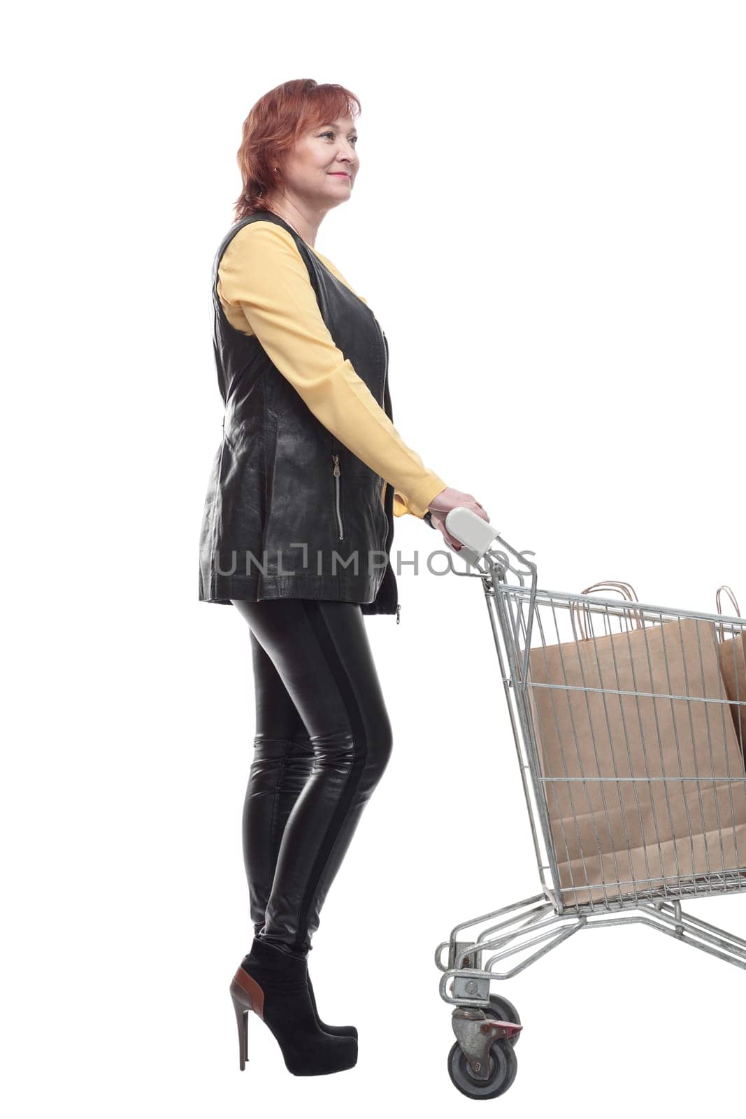 happy mature woman with shopping cart. isolated on a white background.