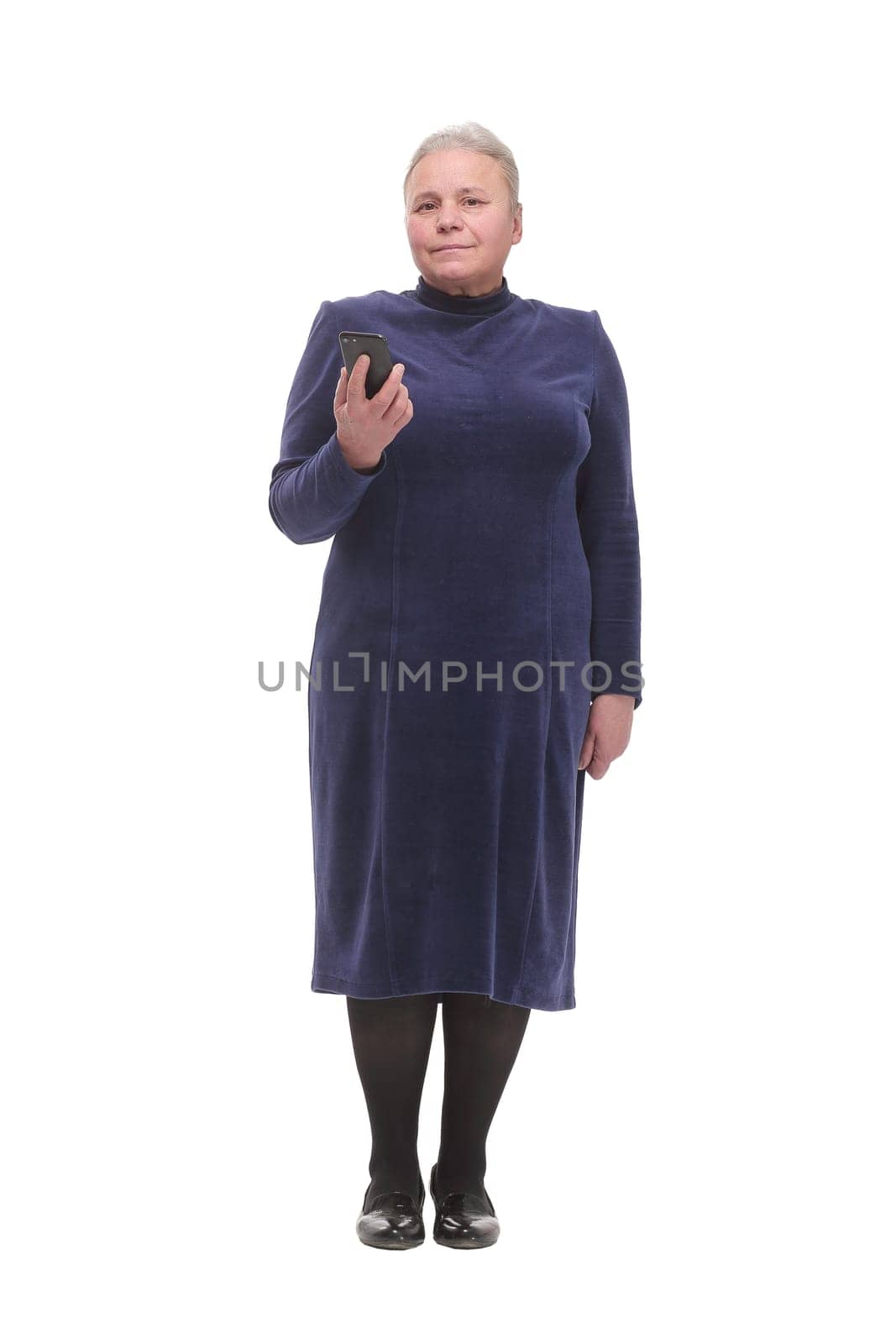 Happy old senior business woman in dress holding cell phone, smartphone in hand read and write sms. Isolated over white background
