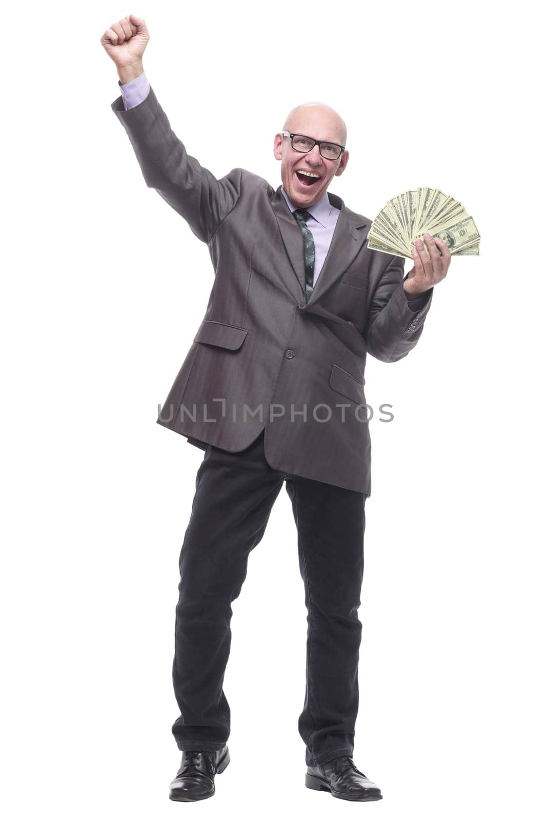 in full growth. happy business man with dollar bills. isolated on a white background.