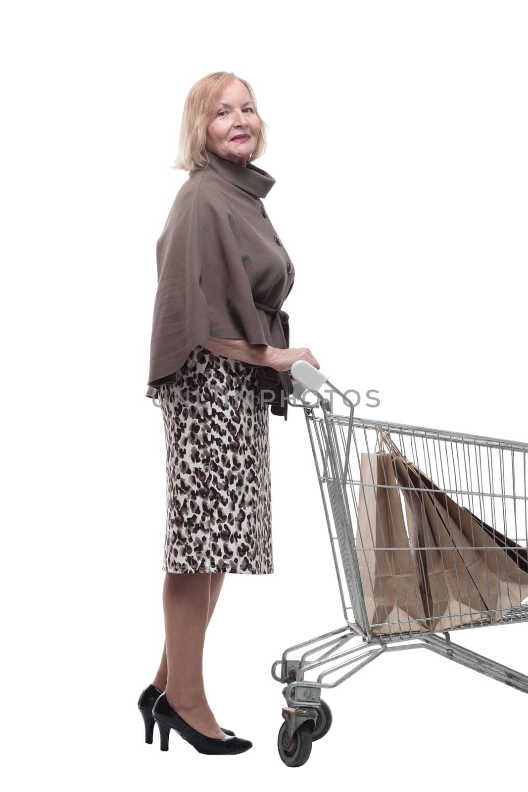 attractive mature woman with shopping cart . isolated on a white background.