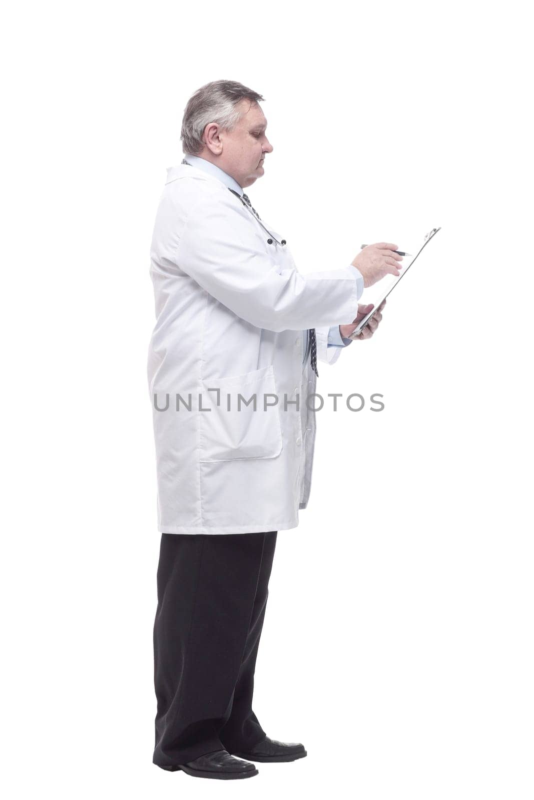 in full growth.competent doctor with clipboard. isolated on a white background.