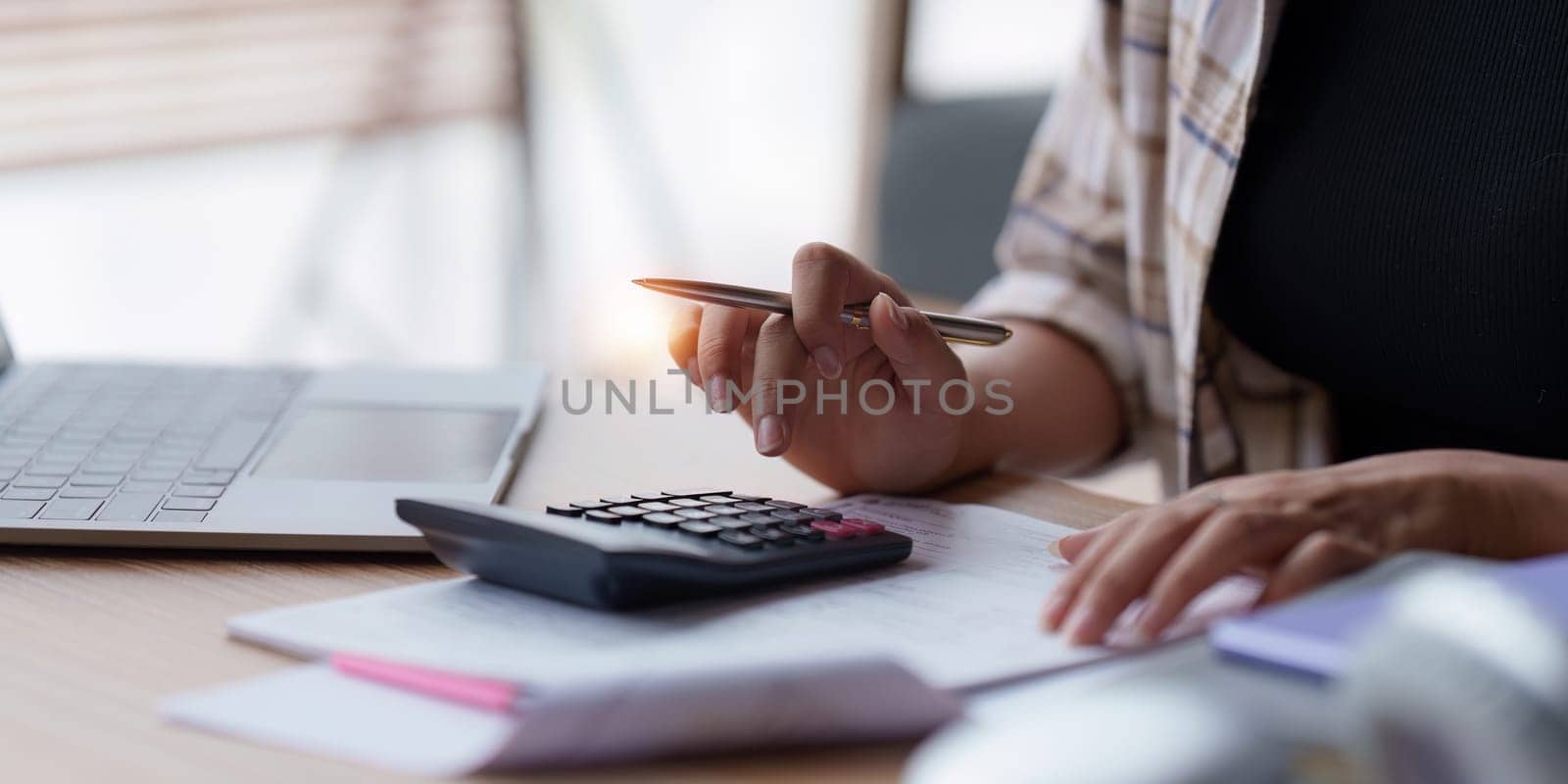 Asian accounting professional calculating household bills, reviewing and analyzing household bills, and filing tax returns..
