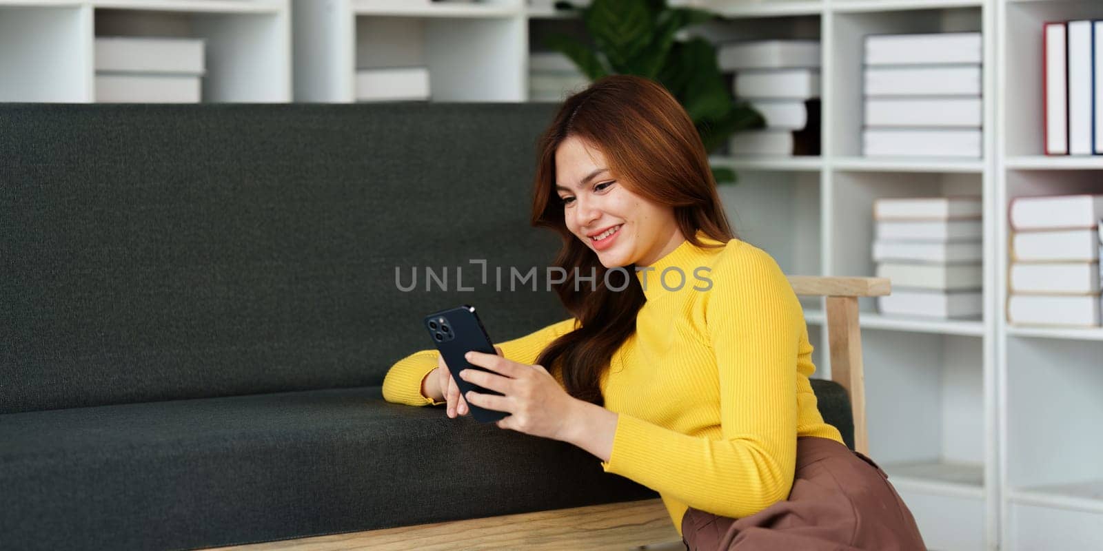 Attractive Asian woman resting comfortable living room and using mobile phone, Relax, Sofa, Lifestyle.
