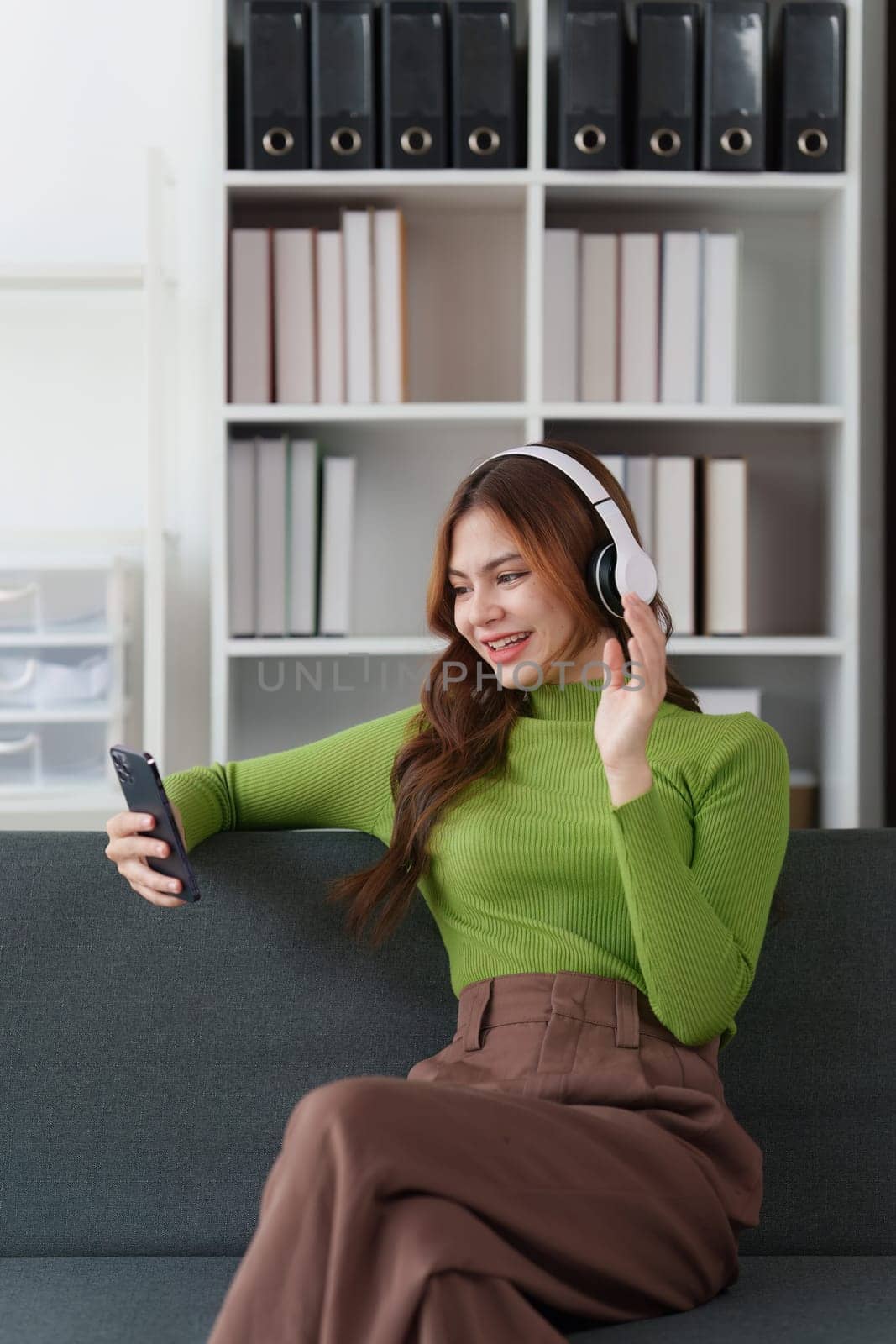 Attractive Asian woman resting comfortable living room and using mobile phone, Relax, Sofa, Lifestyle.