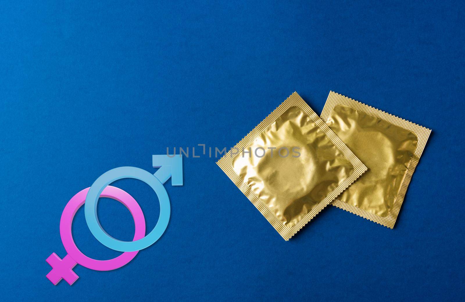 condom in wrapper pack and Male, female gender signs by Sorapop