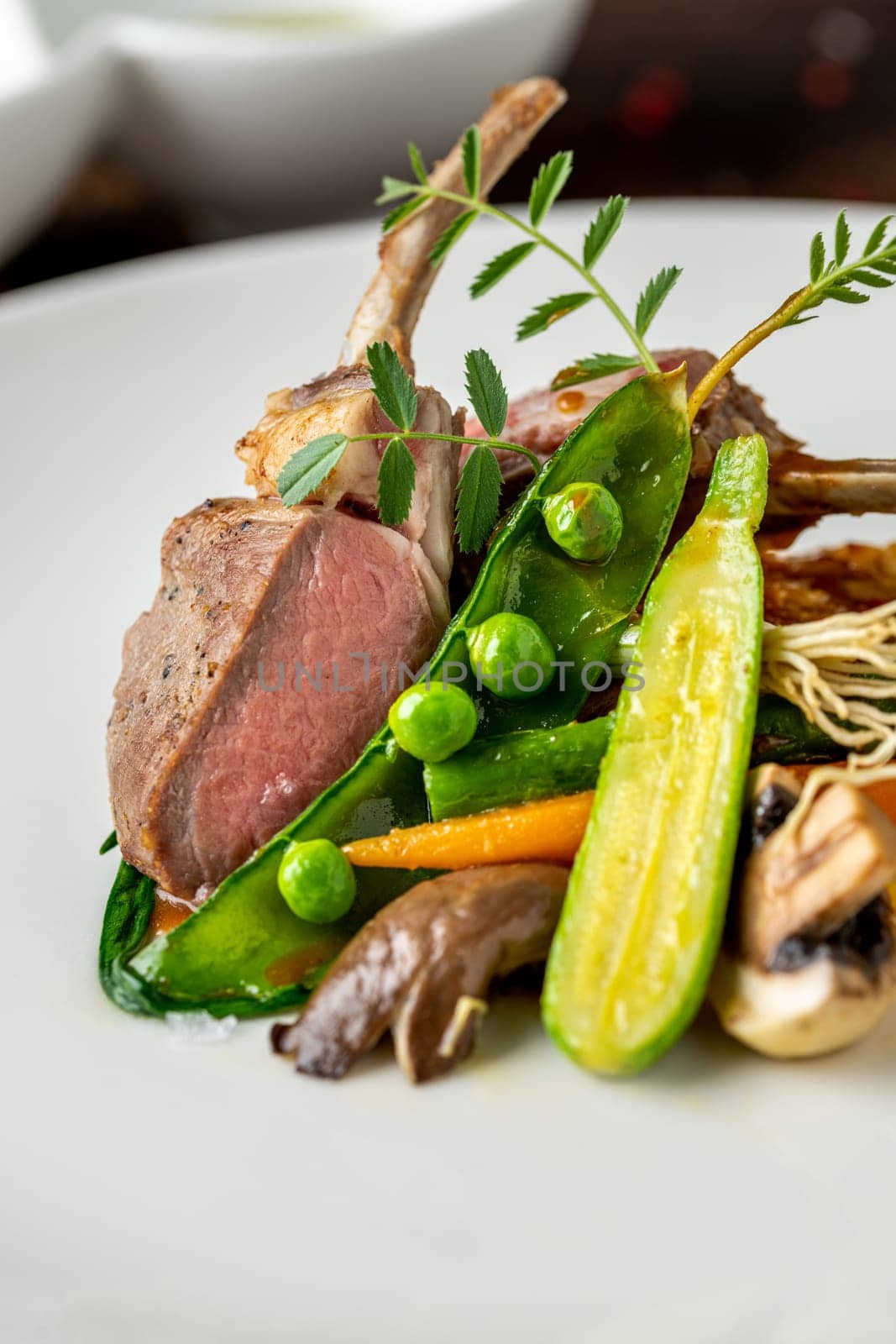 lamb chops with various vegetables at a fine dining restaurant