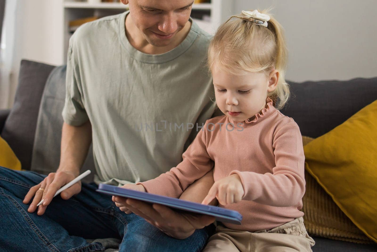 Deaf child girl with cochlear implant studying to hear sounds and have fun with father - recovery after cochlear Implant surgery and rehabilitation concept by Satura86