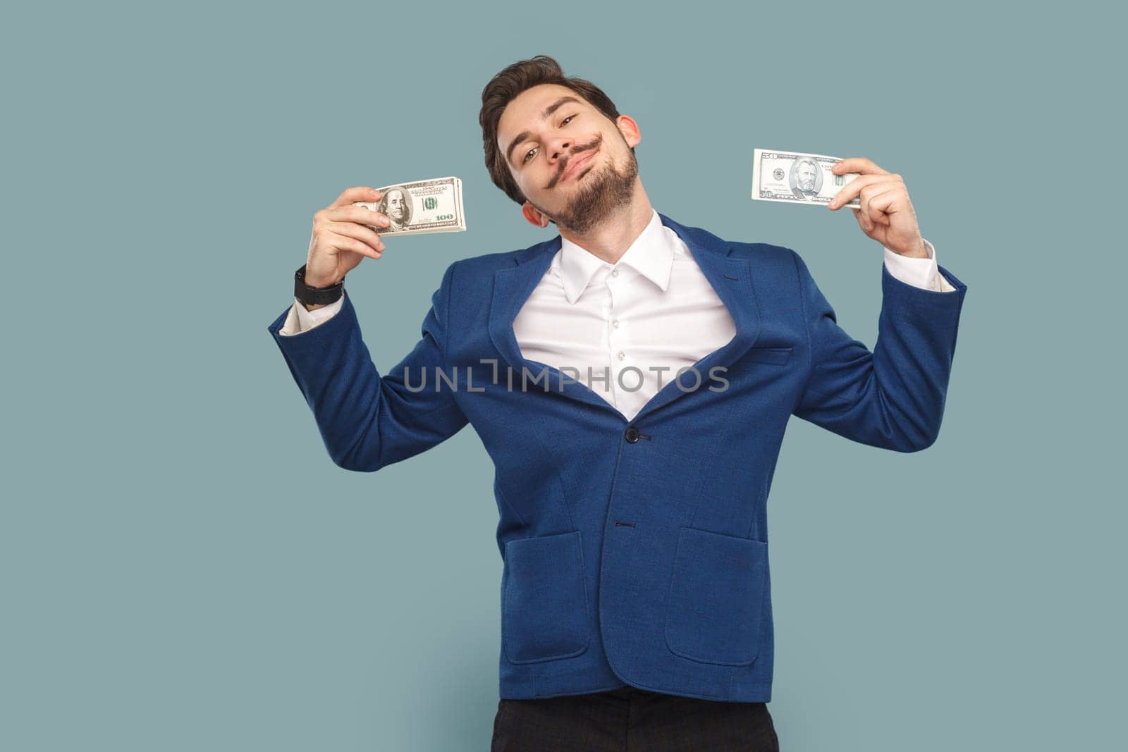 Happy smiling delighted man standing with dollar banknotes and looking at camera with pride. by Khosro1