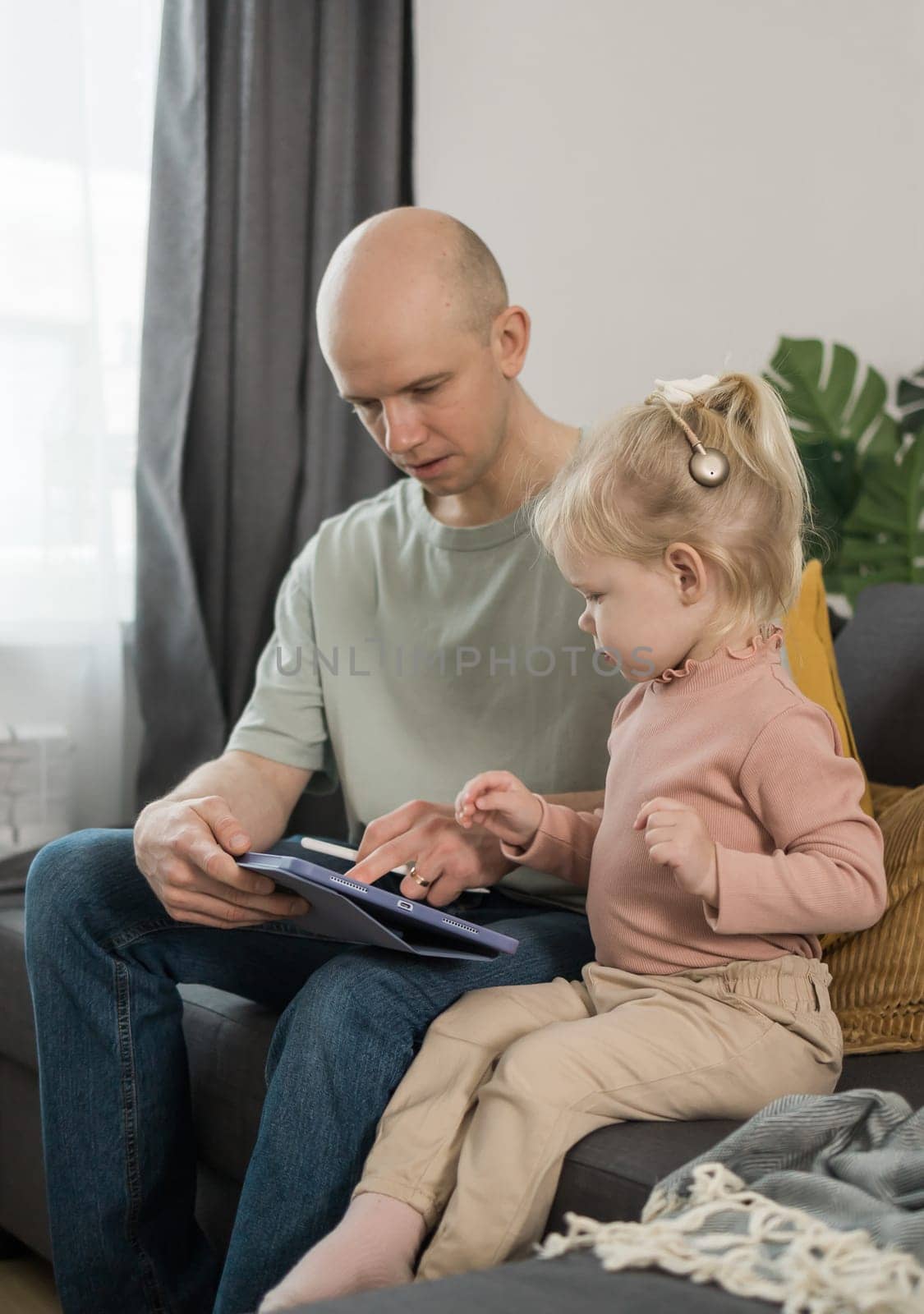 Deaf kid with hearing aid cochlear implant have fun with parents - Hear aid and medicine innovating technology and diversity