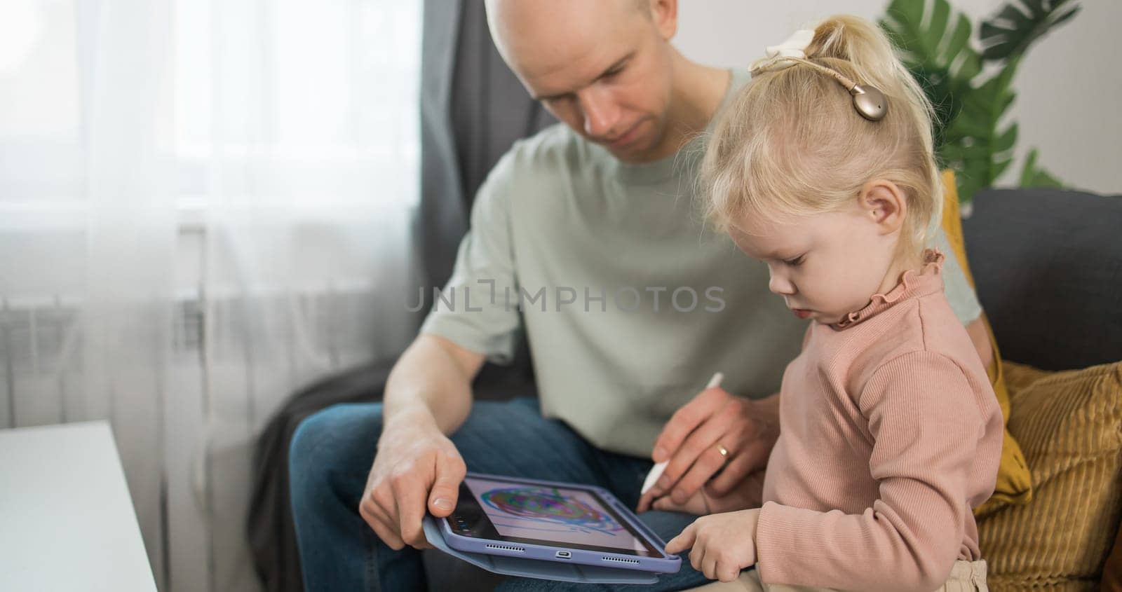 Deaf kid with hearing aid cochlear implant have fun with father - Hear aid and medicine innovating technology and diversity concept by Satura86