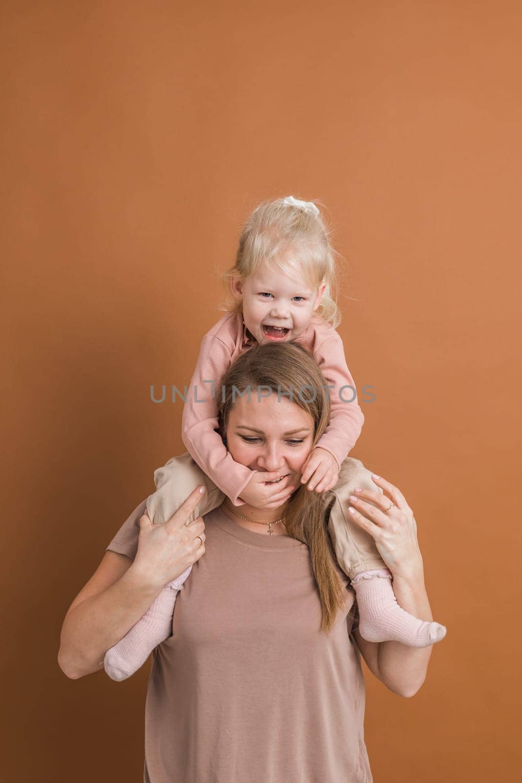 Deaf child girl with cochlear implant studying to hear sounds and have fun with mother - recovery after cochlear Implant surgery and rehabilitation concept by Satura86