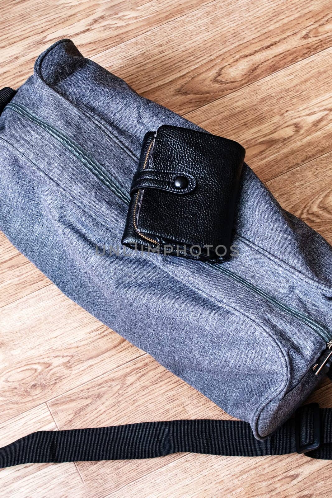 Wallet and travel bag on a wooden background